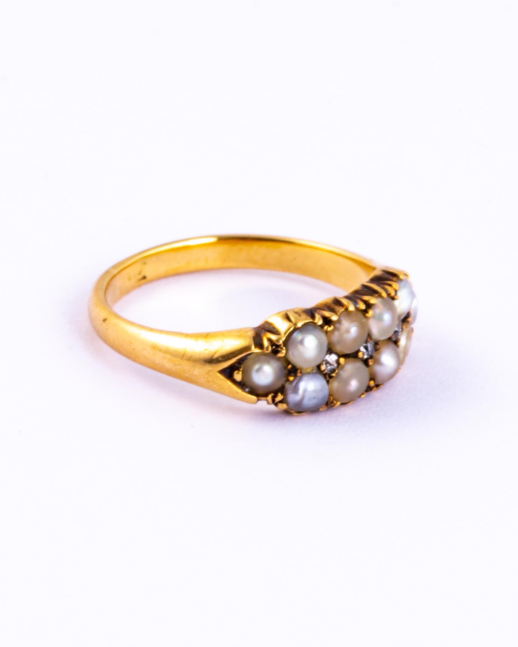 This sweet ring holds two rows of pearls and in-between them are a row of three rose cut diamonds which add the perfect amount of sparkle to this ring. 

Size: K 1/2 or 5 1/2 
Width: 6.5mm

Weight: 4 grams