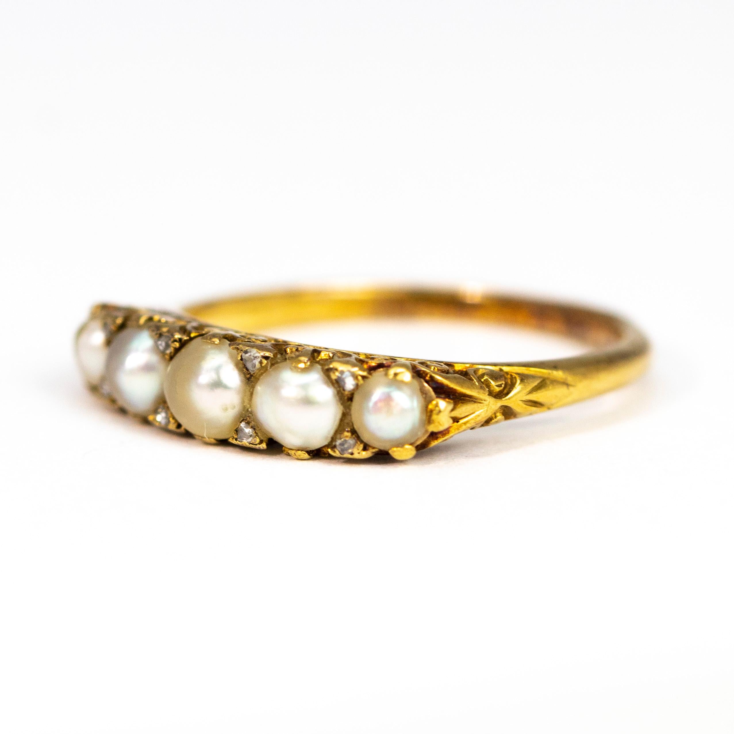 This gorgeous five stone holds five glossy pearls which have rose cut diamond points between each of them. The setting is classically ornate with swirl patterns and is modelled in 18ct gold. 

Ring Size: M or 6 1/4
Width: 4mm

Weight: 2.62g