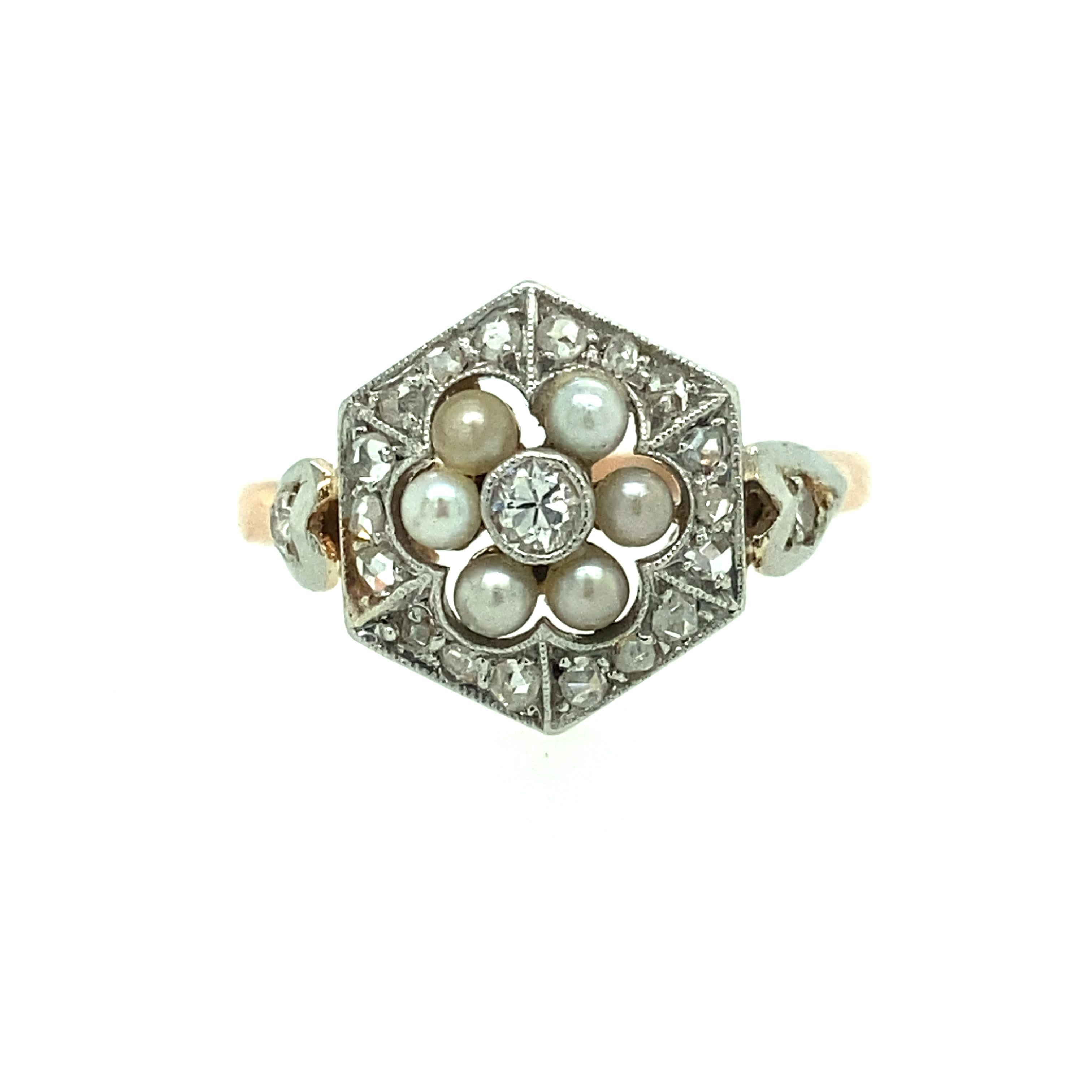 One 14 karat rose gold and platinum Edwardian ring set with six natural pearls and thirty-nine rose and European cut diamonds, approximately 0.50 carat total weight with matching I/J color and I1 clarity.  The ring is a finger size 6.25. 