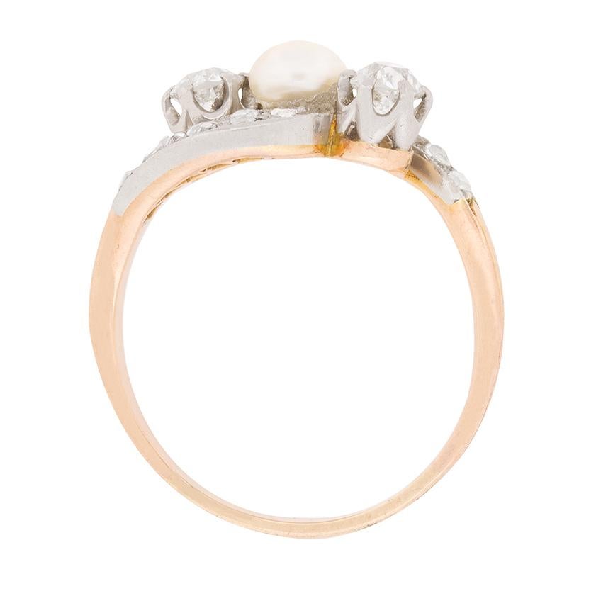 This stunning ring features a natural pearl in the centre, highlighted by two beautiful diamonds adjacent. The diamonds each weigh 0.20 carat and are G in colour and VS in clarity. They shine within their claw settings which will have been hand