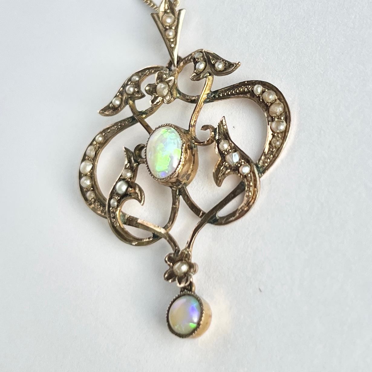 This sweet pendant holds seed pearls and colourful opals. The pendant and chain is modelled in 9carat gold.

Drop from loop: 30mm
Pendant Width: 35mm
Chain length: 46cm

Weight: 3.8g