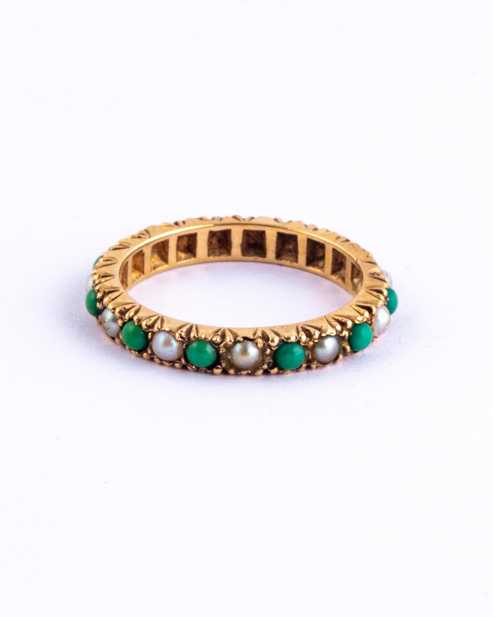 This ring is an absolute stunner! You don't find this style of ring very often. The 9 carat gold band hold pearls and turquoise stones each held in simple claw settings. There is engraved detail on the side of the band. 

Ring Size: M 1/2 or 6 1/2