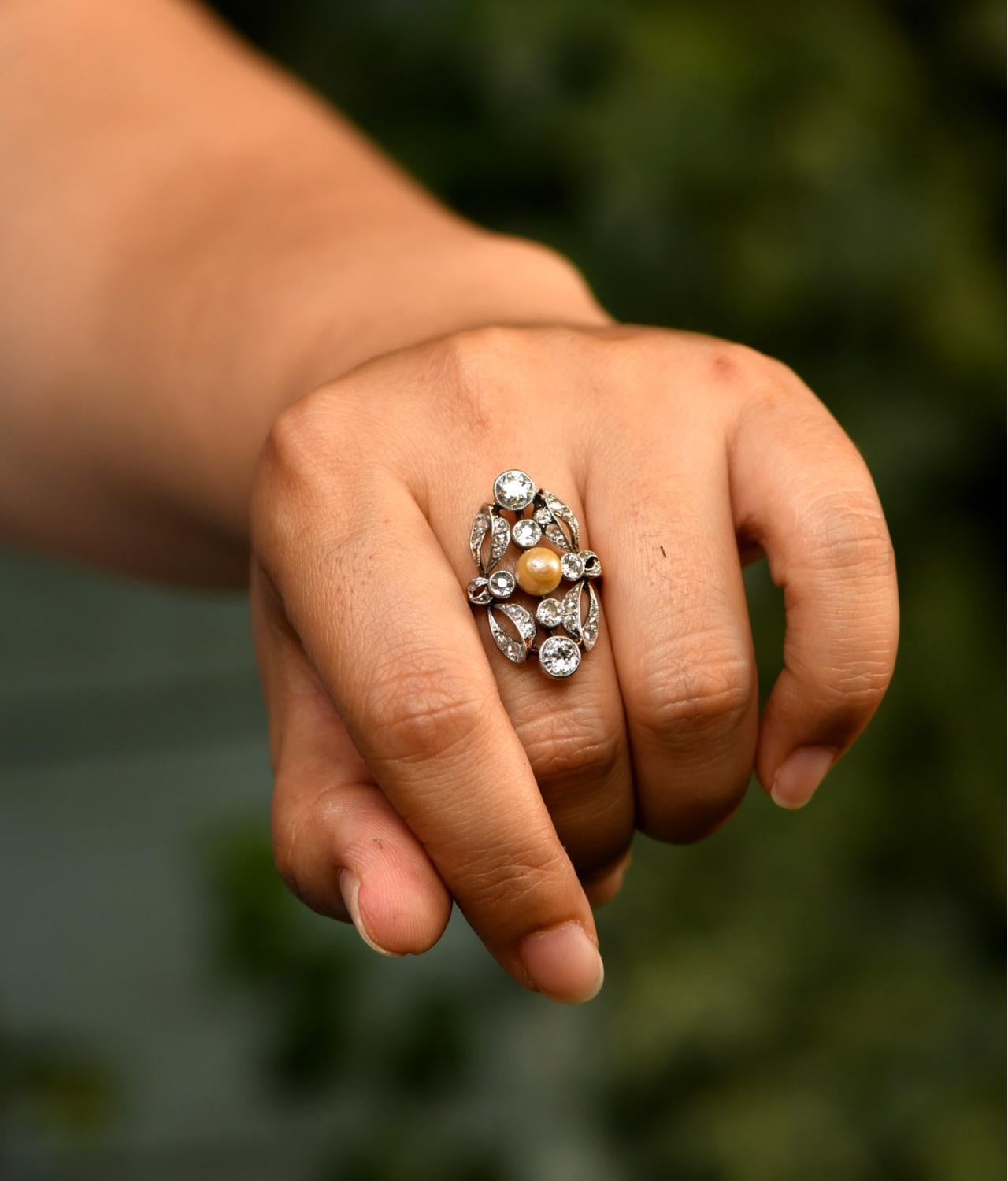 This a one-of-a-kind antique French ring. This beautifully hand crafted diamond and pearl ring is classic Edwardian style. The central pearl is 6 mm pearl set in a very elegant platinum setting. The taste and the detail work of this ring is