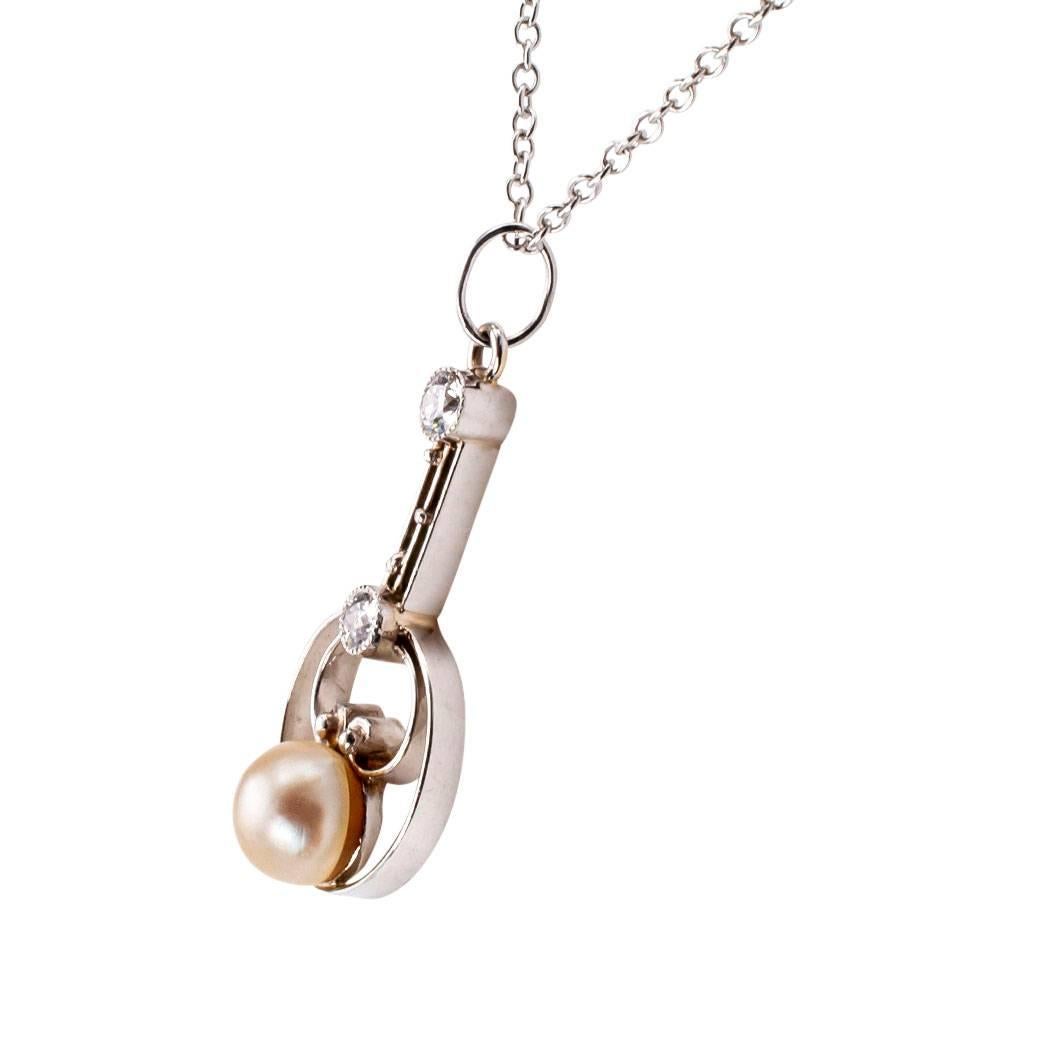 Edwardian 1910 pearl diamond and platinum lavalier. Dainty and minimalist, the handcrafted design showcases a single round pearl on a delicate platinum frame decorated by a pair of bezel-set diamonds totaling approximately 0.07 carat, approximately