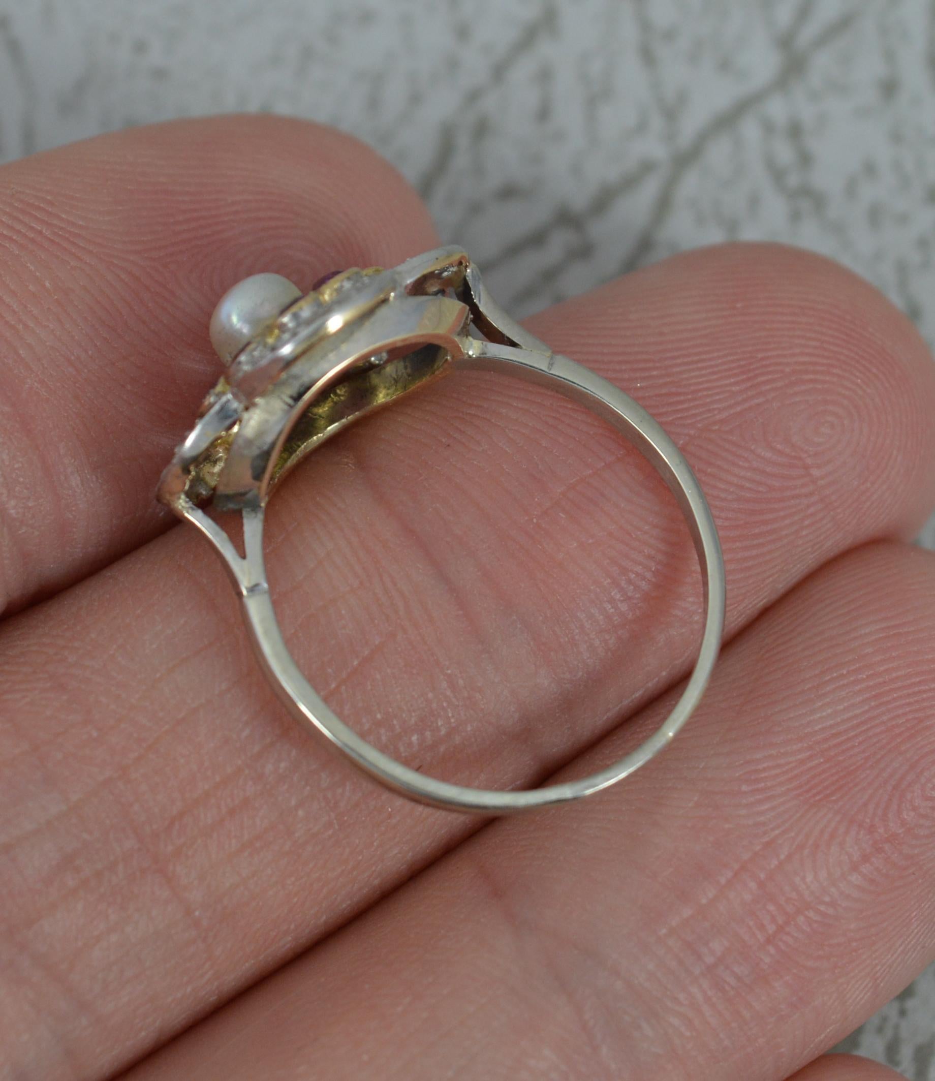 small gold flower ring with a pearl in the middle