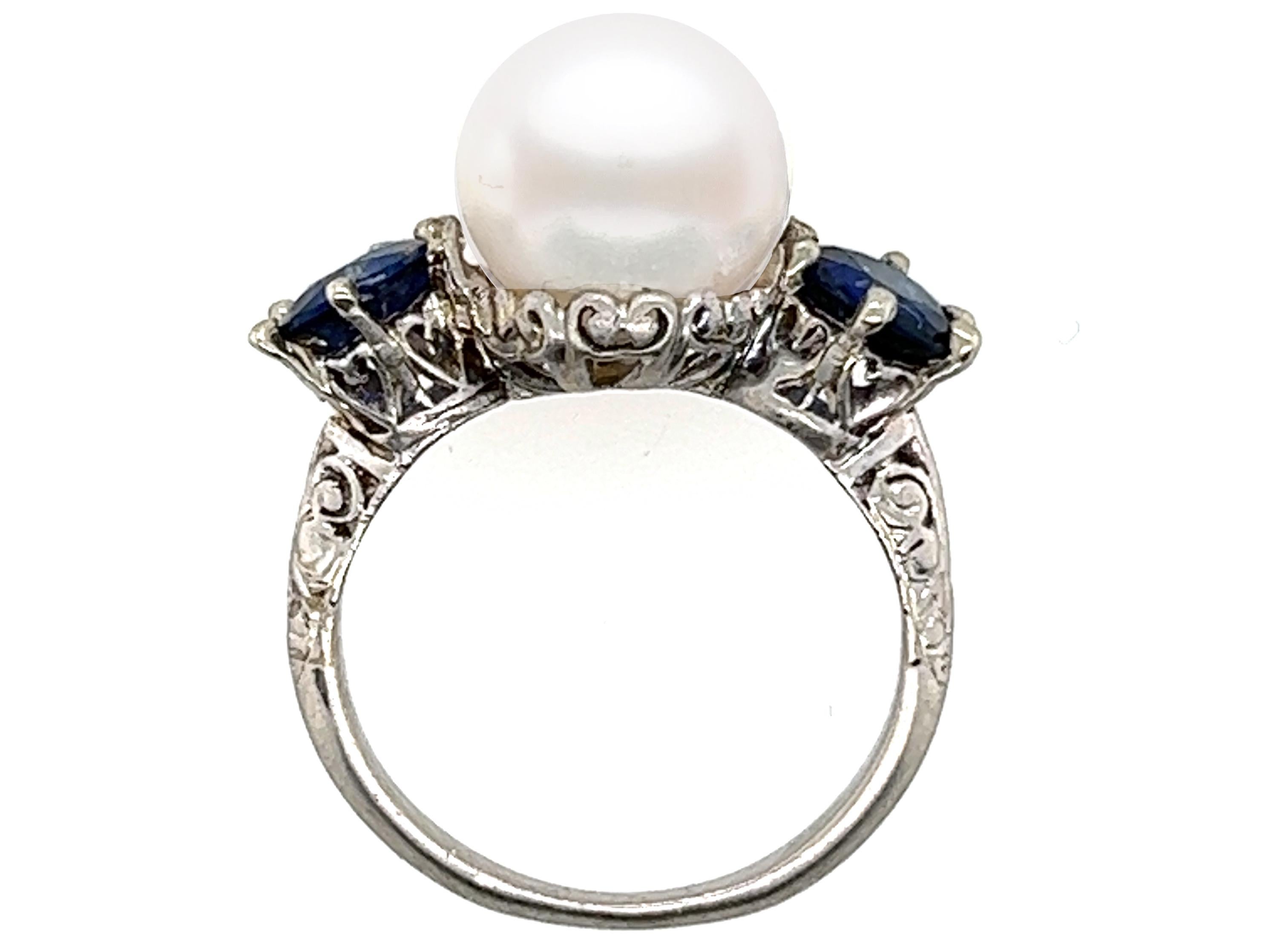 Genuine Original Antique from 1900s Pearl 1.45ct Sapphire Platinum Edwardian 3 Stone Engagement Ring 



Featuring a Gorgeous Genuine Natural 10.5mm Gem Pearl Center

Magnificent Sapphires Caress the Sides 

Artful Engraving Intensely