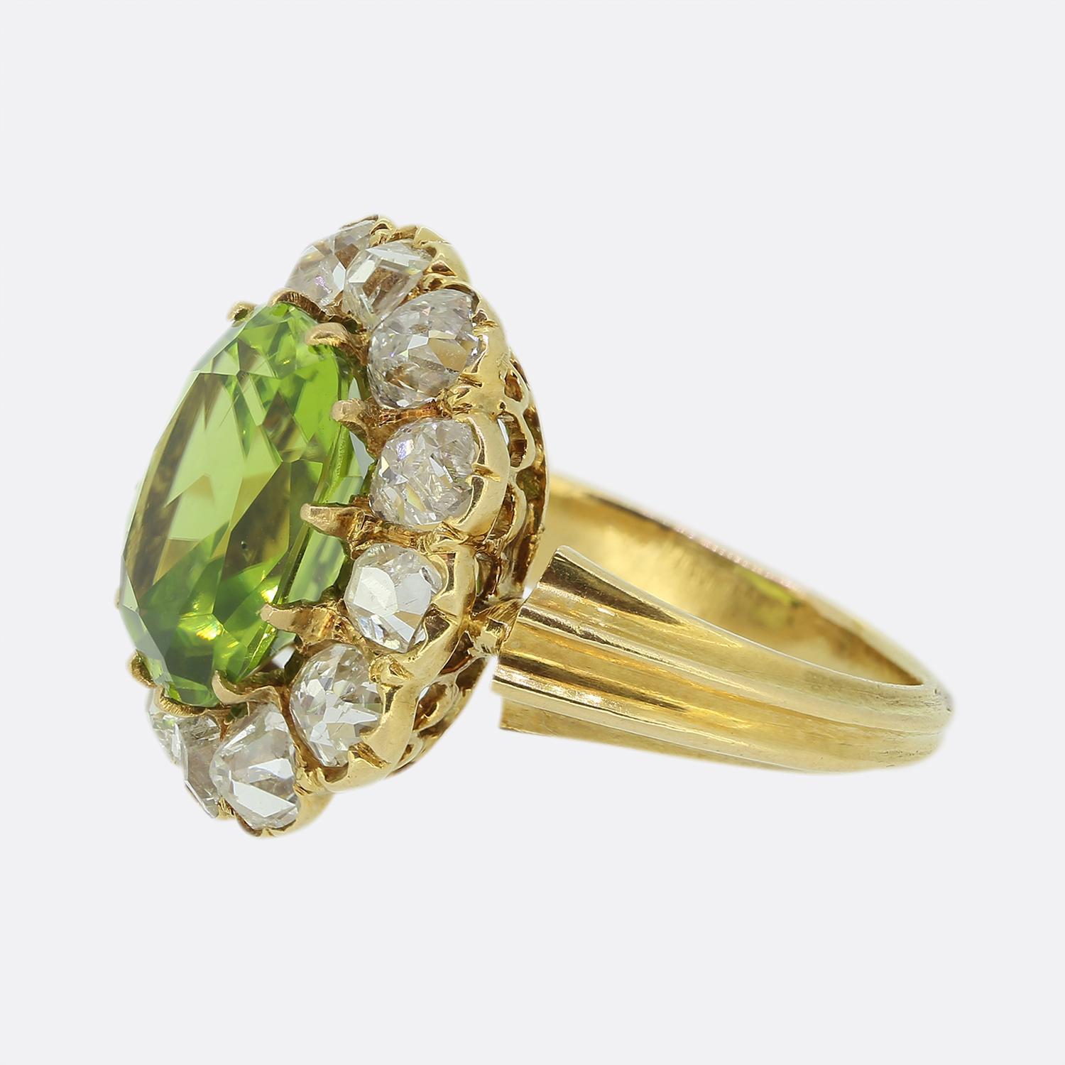 This is a wonderful 18ct yellow gold ring dating back to the early 1900s. The ring plays host to a centralised rich green peridot which is surrounded by twelve chunky old cut diamonds. The bright white of the diamonds highly compliments the mid to