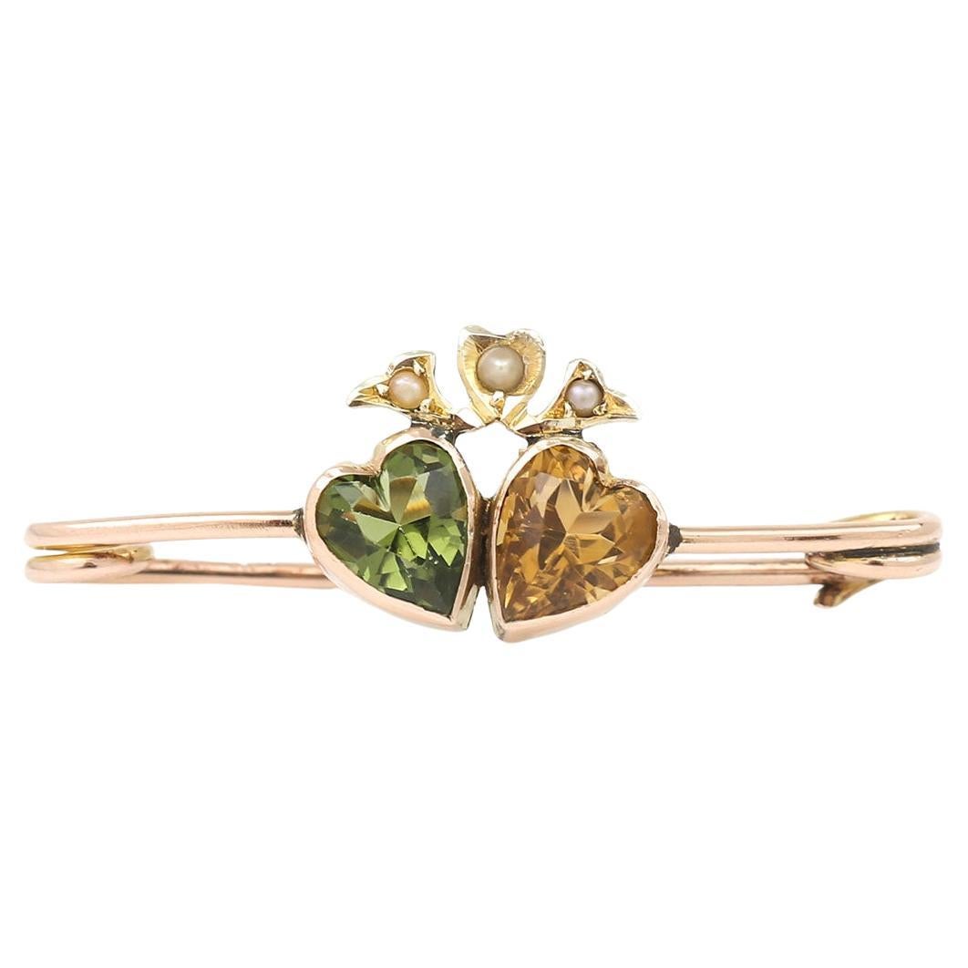 Edwardian Peridot, Citrine and Pearl Twin Heart Brooch, circa 1910 For Sale