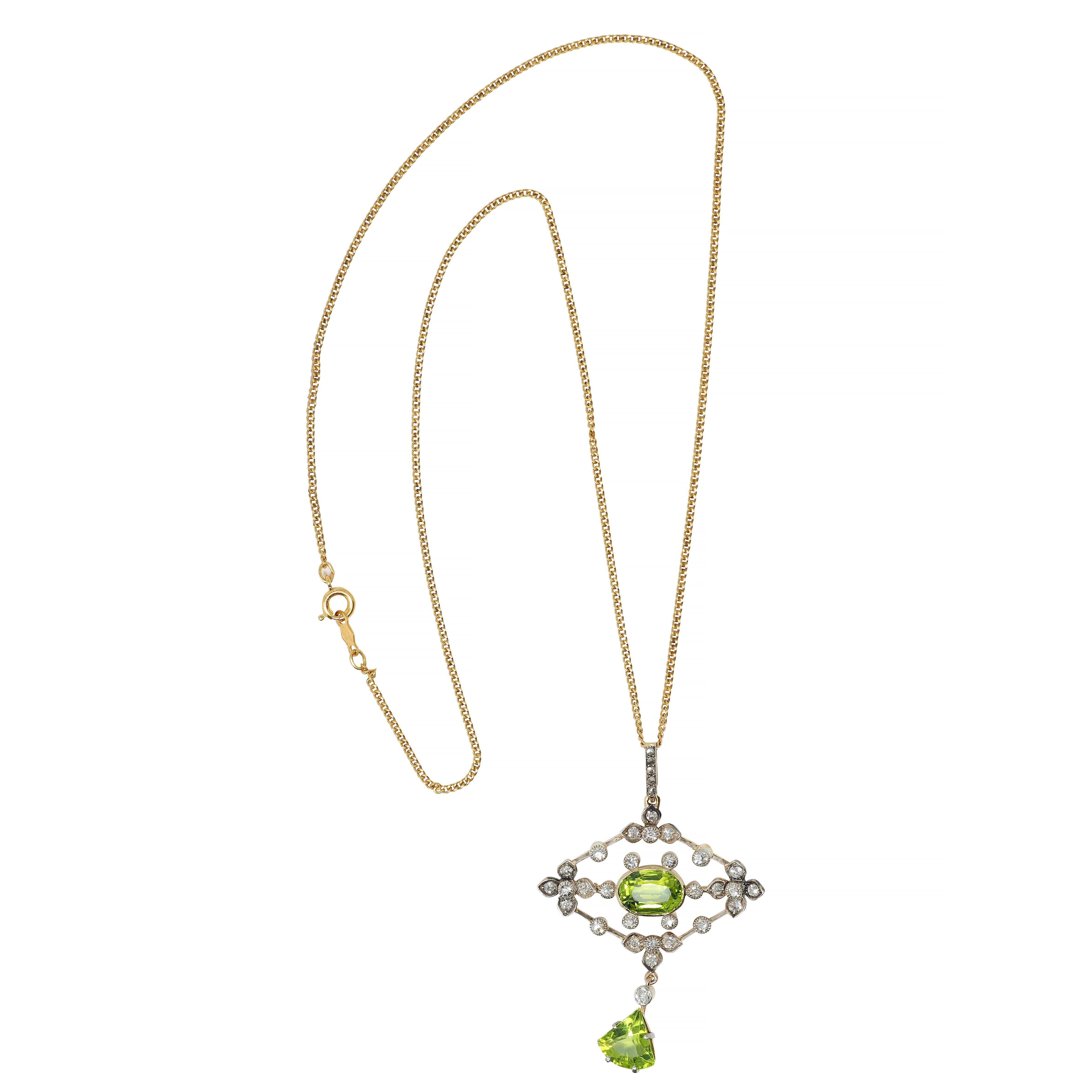 Designed as a 1.5 mm curb link chain suspending a bale and pierced trapezoid-shaped pendant 
With highly rendered silver-topped foliate motif and centering an oval cut peridot 
Suspending an additional shield cut peridot articulating as a drop -