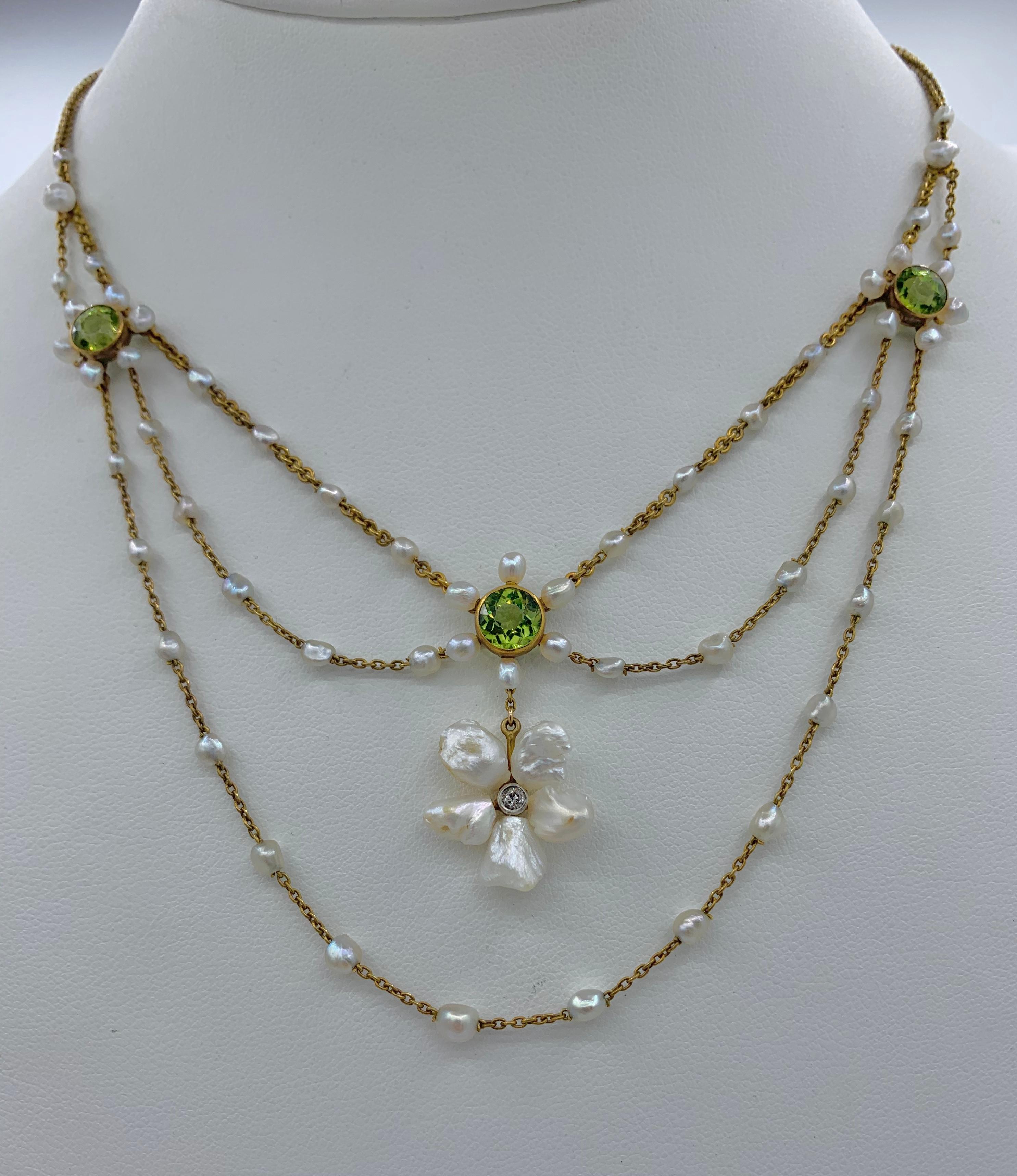 THIS IS A STUNNING VICTORIAN - ART NOUVEAU - BELLE EPOQUE FESTOON NECKLACE WITH THE MOST GORGEOUS NATURAL ROUND FACETED PERIDOT GEMS SET WITH PEARLS AND AN OLD MINE DIAMOND IN A GORGEOUS FLOWER MOTIF FESTOON SWAG DESIGN IN 14 KARAT GOLD.   THE