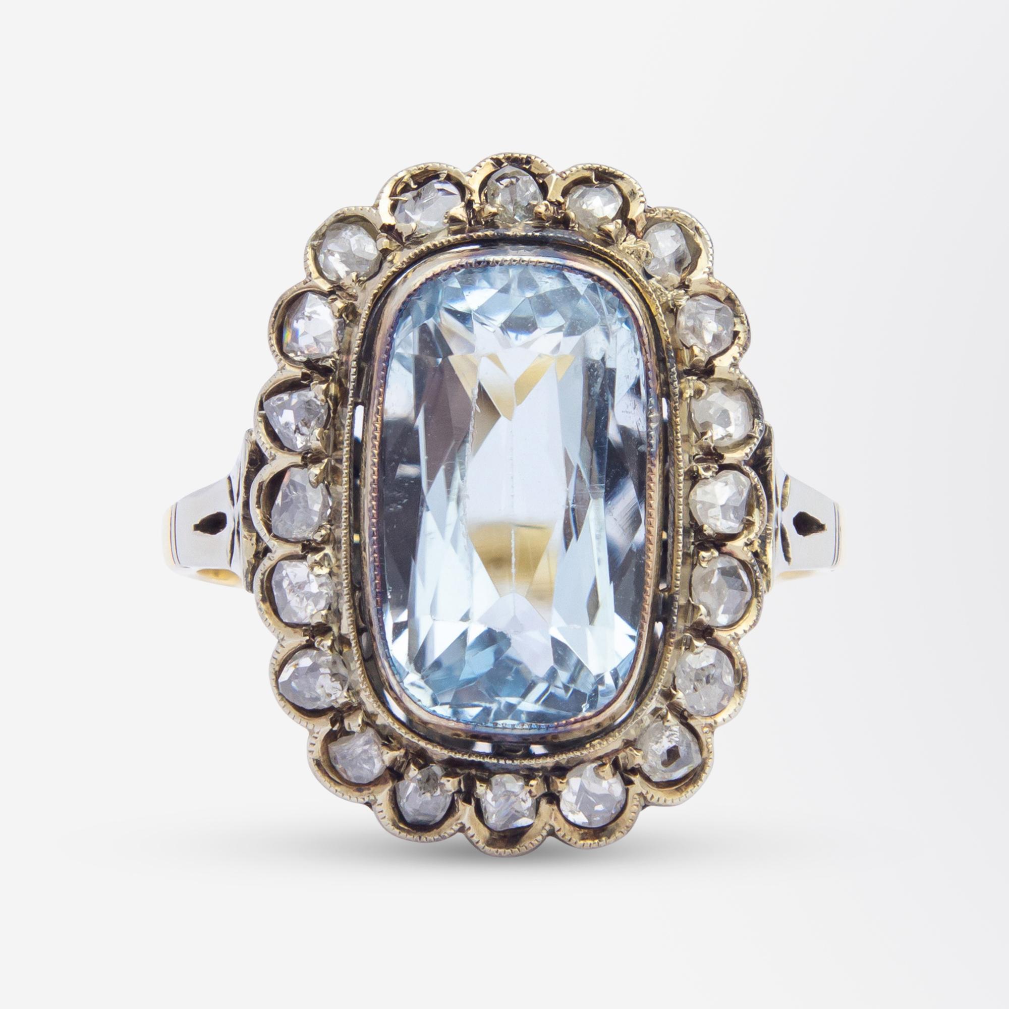 This Edwardian era aquamarine and diamond ring has been crafted from 18 karat yellow gold. The central oval cut aquamarine measures 3.50 carat and is surrounded by a halo of 20 rose cut diamonds of I/J colour and SI/P1 clarity totalling 0.60 carat.