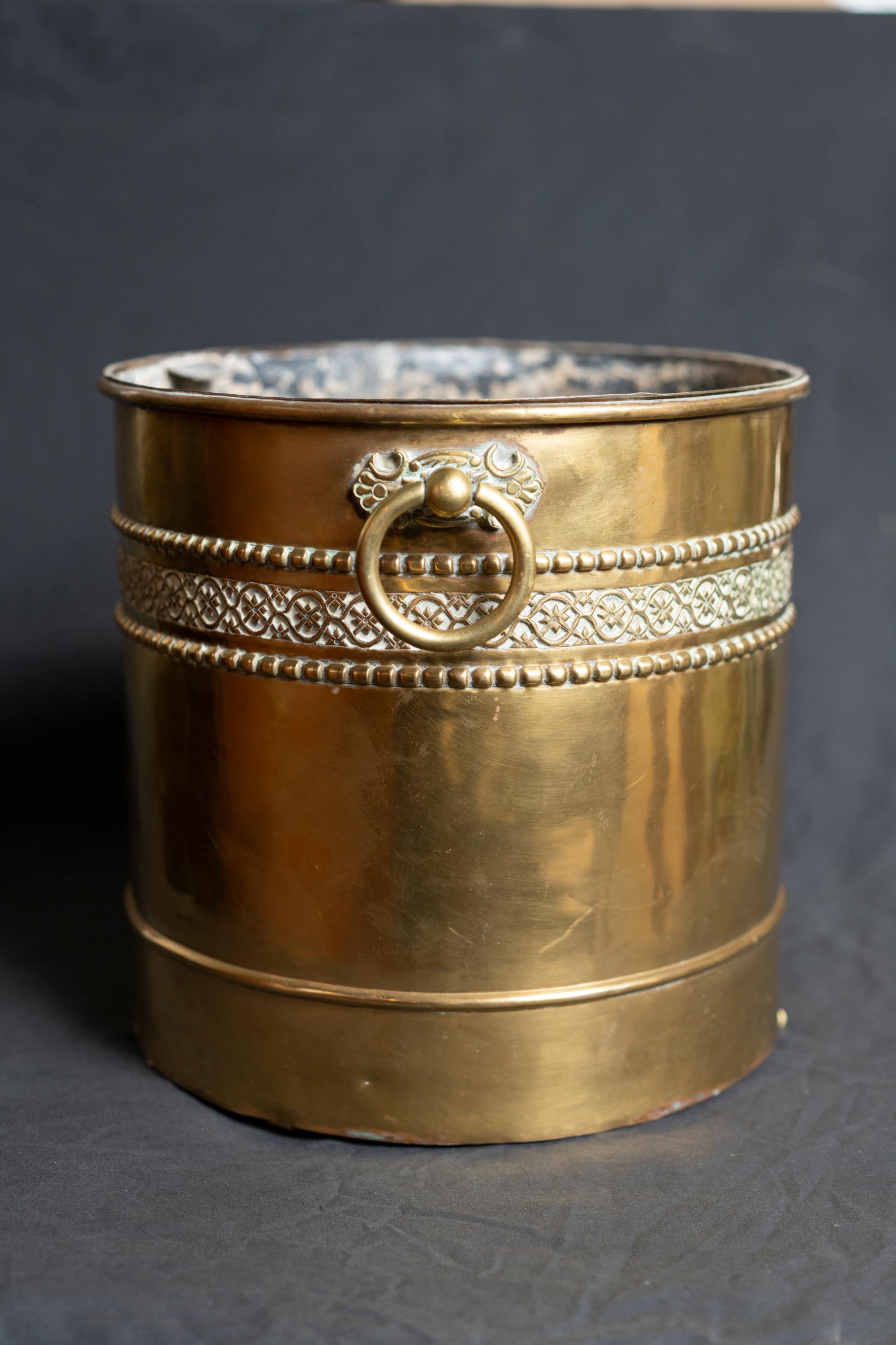 Edwardian period brass planter with solid brass handles 
the diameter interior 11.75 in.
 