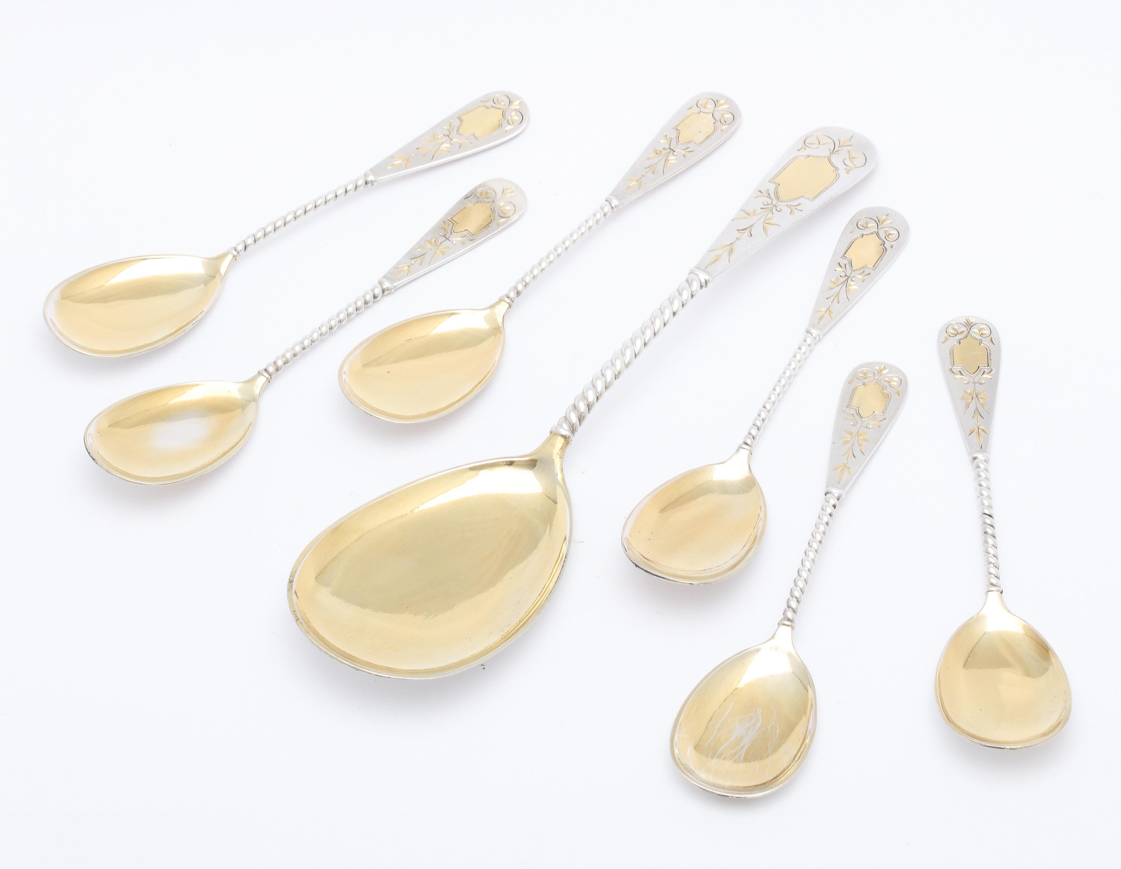 Edwardian Period, Continental silver (.800), parcel gilt ice cream /dessert set, Germany, ca. 1910. Set consists of a large serving spoon which is 8 inches long x 2 1/8 inches deep (at deepest point)  and 6 eating spoons, each measuring 5 1/4 inches