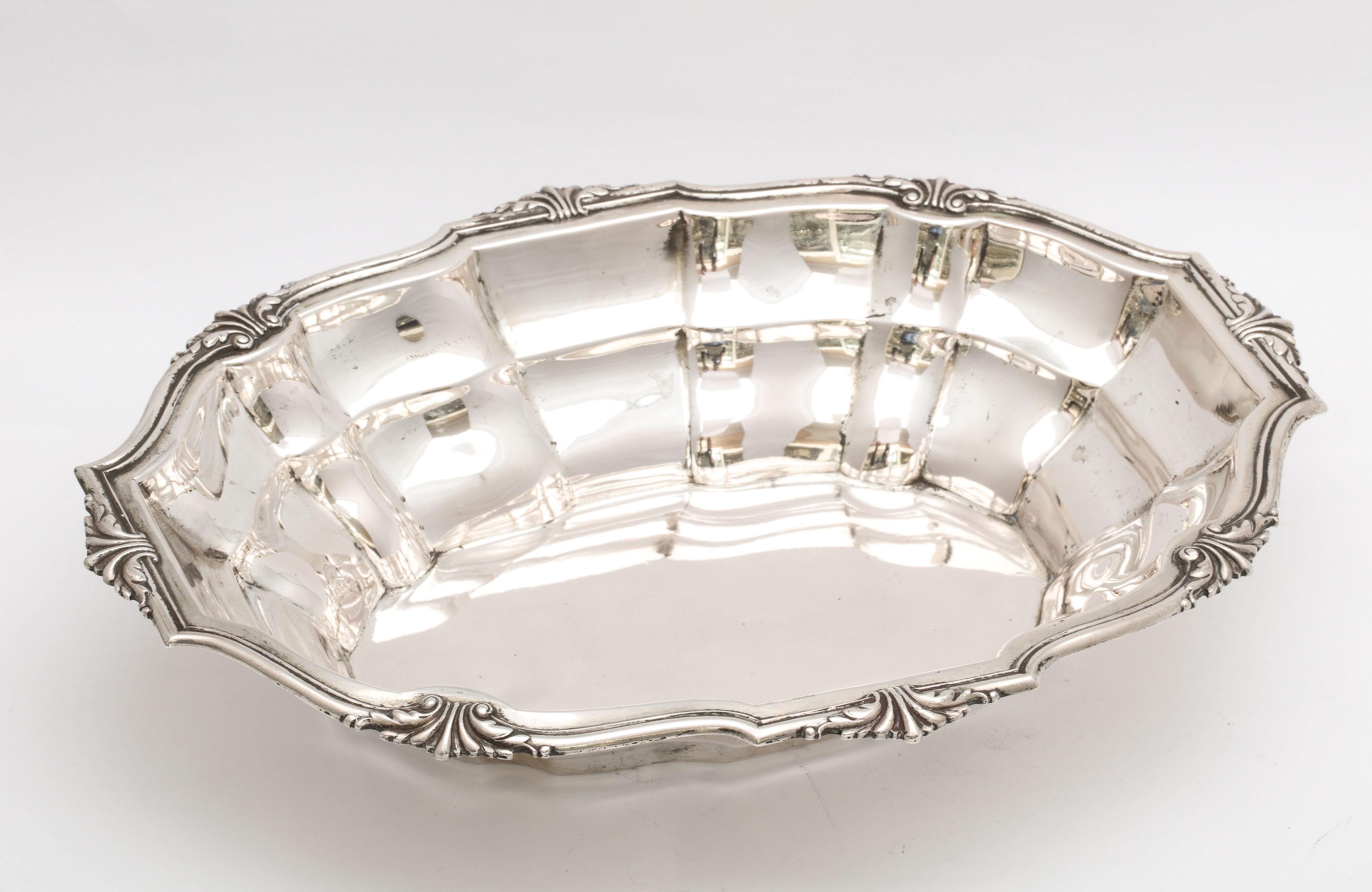 Edwardian Period, Continental Silver (.800) serving bowl, Austria, Ca. 1915. Fluted design. Measures 11 1/2 inches wide x 8 1/2 inches deep x 2 1/4 inches high (at highest point). Weighs 13.085 troy ounces. Dark areas in photos are reflections. In