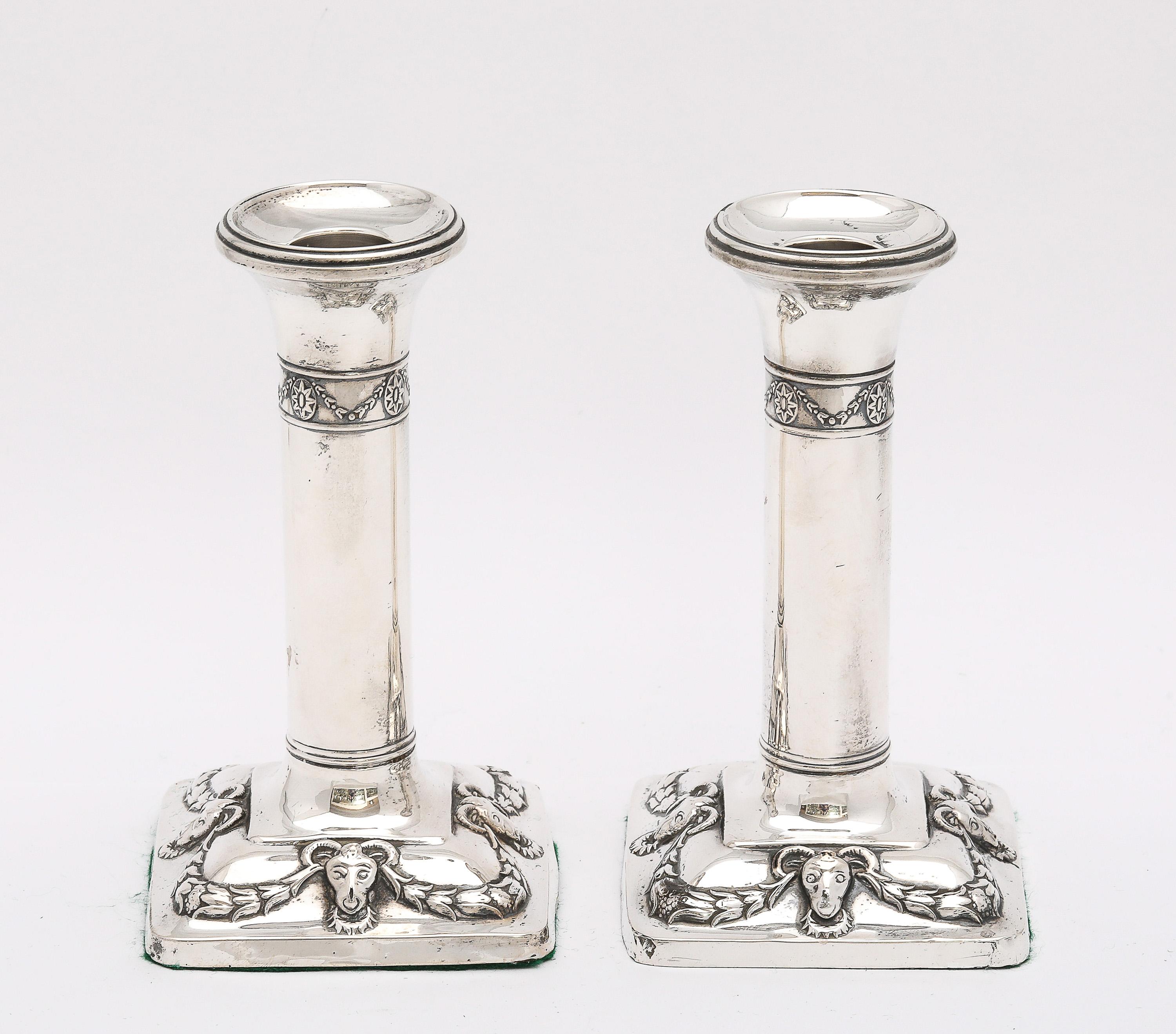 Edwardian Period, pair of sterling silver, Neoclassical-Style candlesticks, Birmingham, England, year-hallmarked for 1909, H. Matthews - maker. Each candlestick stands 5 1/2 inches high x 3 inches wide (at widest  point) x 3 inches deep (at deepest
