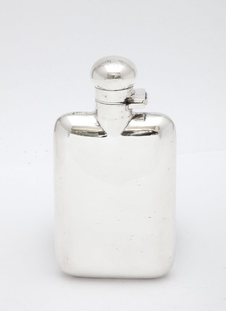 Edwardian Period, sterling silver flask with hinged lid (having a bayonet closure), Birmingham, England, year-hallmarked for 1917, H. Matthews - maker. Measures over 4 3/4 inches high (at highest point) x 2 1/2 inches wide (at widest point) x 1 inch