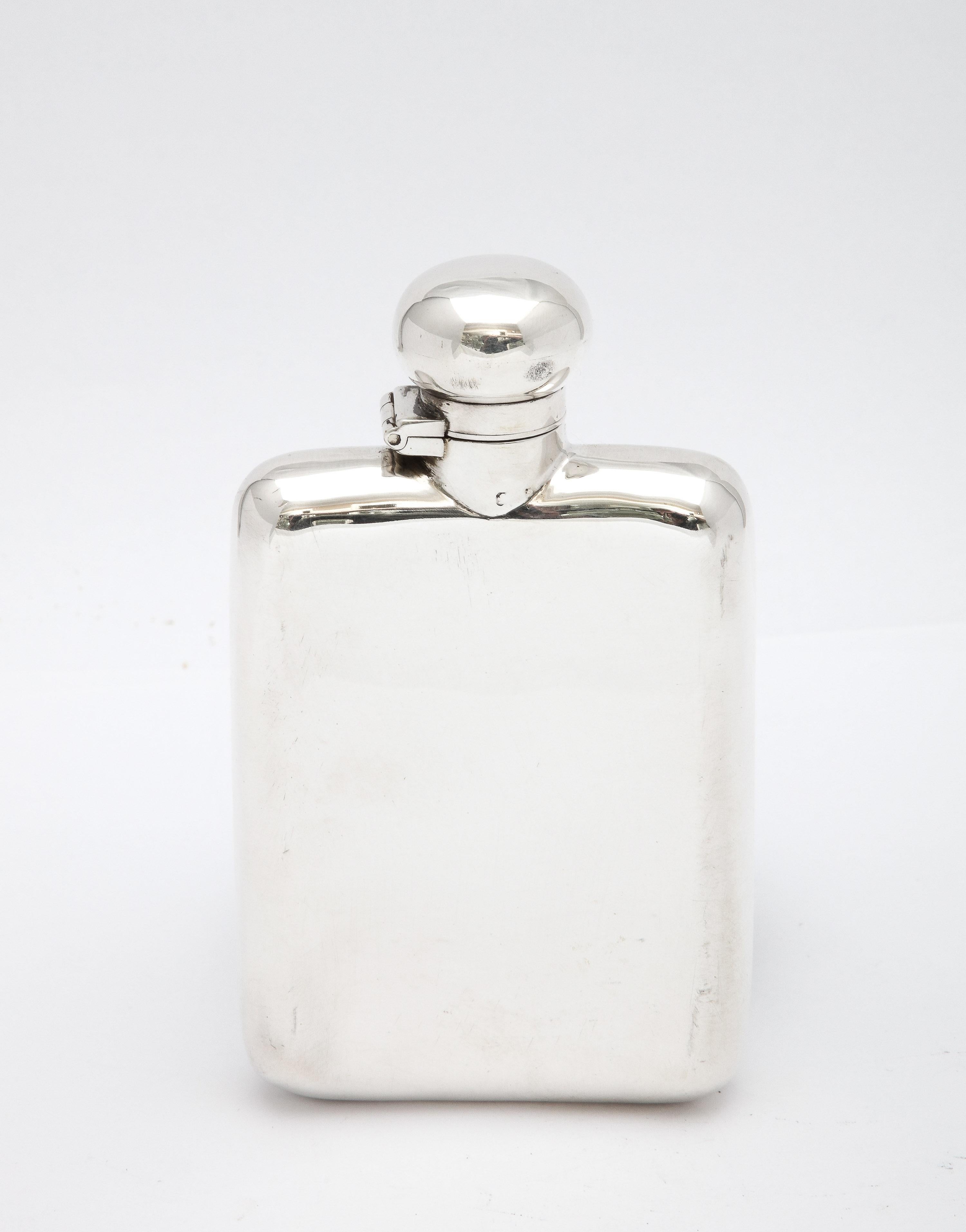 Edwardian Period, sterling silver flask having a hinged lid with bayonet closure, 
Birmingham, England, year-hallmarked for 1900, Charles Saunders and Frank Shepherd - makers. Curved design allows flask to fit easily into a pocket. Measures 4 3/4