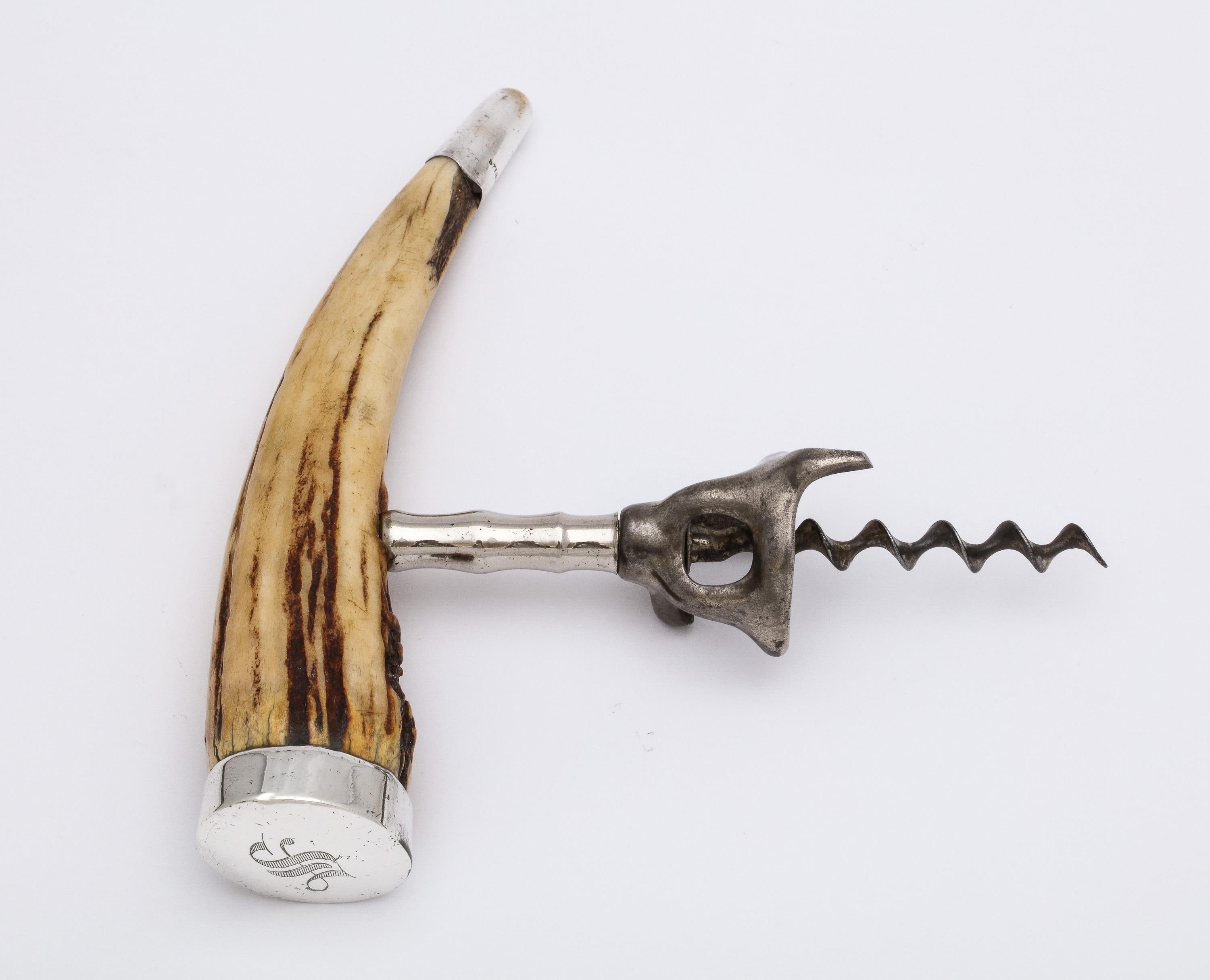 Edwardian period, sterling silver-mounted boar's tusk corkscrew, New York, circa 1905, Wilcox and Wagoner - makers. Measures almost 6 1/2 inches wide (at widest point) x 6 inches high x 1 1/2 inches deep. One of the sterling silver mounts is