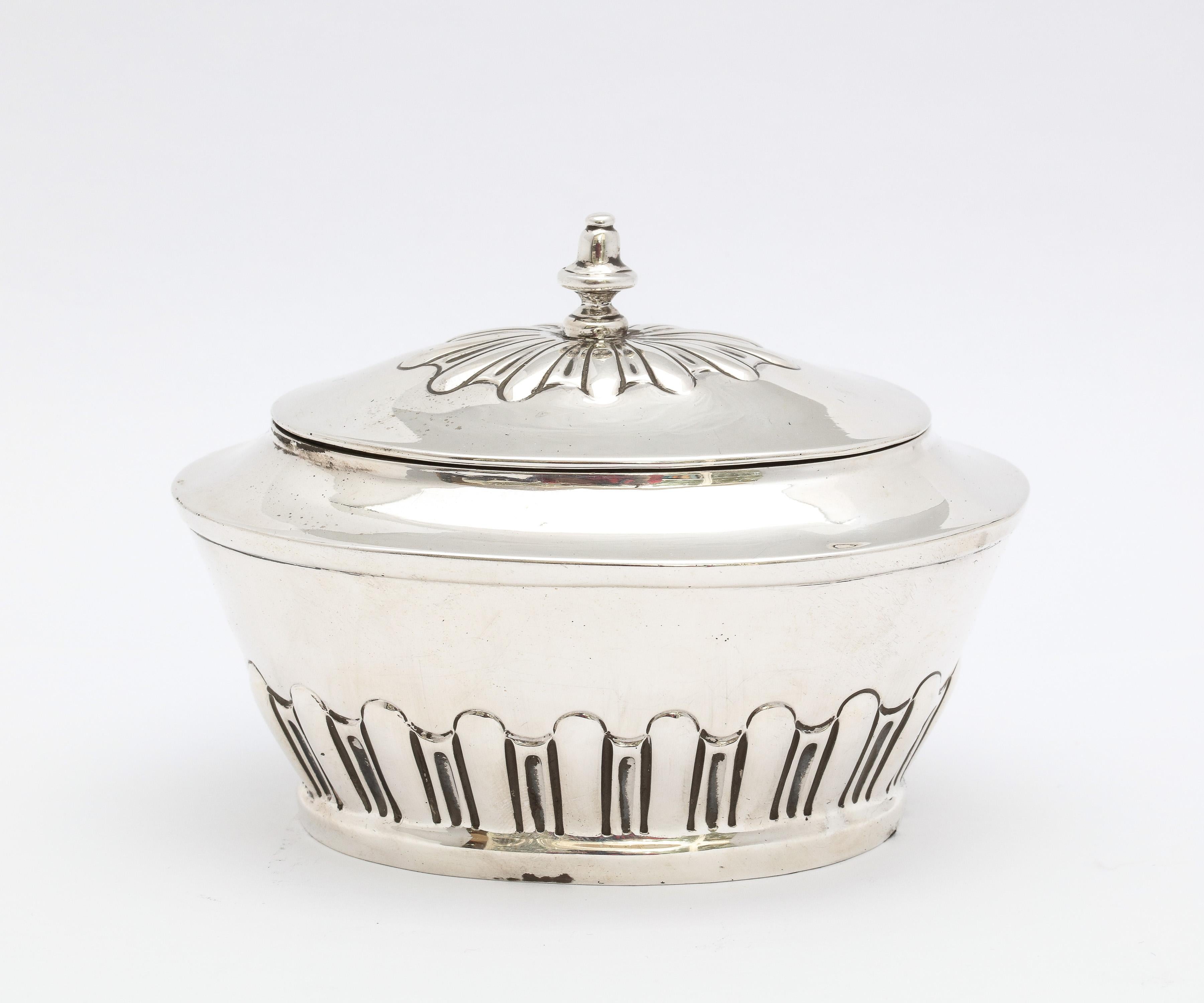 Edwardian Period, sterling silver tea caddy with hinged lid and gilt interior, London, year-hallmarked for 1908, Pairpoint Brothers - makers. Measures 3 1/2 inches high (to top of finial) x 4 1/2 inches wide x 3 inches deep. Weighs 3.1510 troy