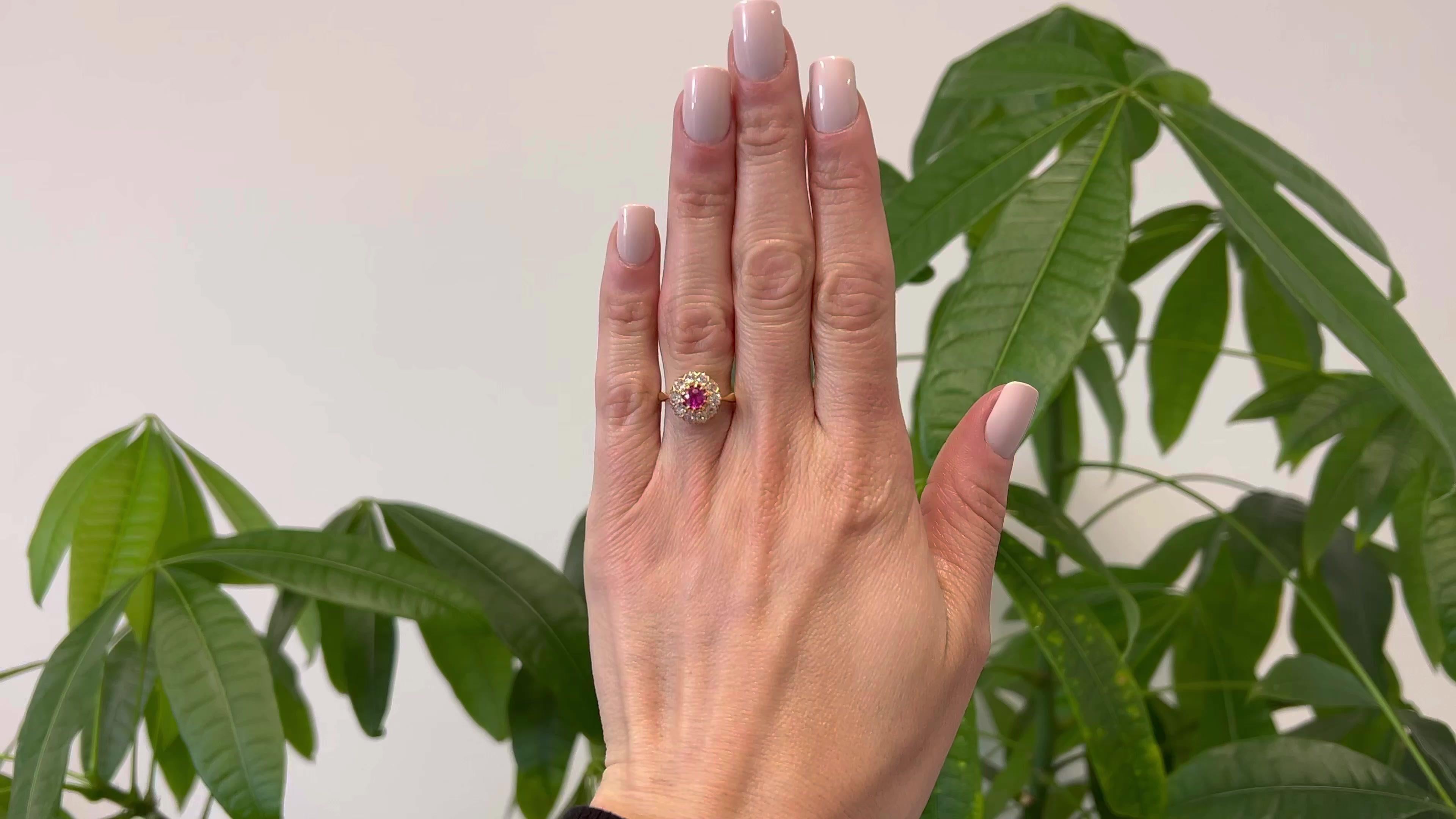 One Edwardian Pink Sapphire Diamond 18k Yellow Gold Cluster Ring. Featuring one round mixed cut pink sapphire weighing approximately 0.40 carat. Accented by 10 old mine cut diamonds with a total weight of approximately 0.70 carat, graded near