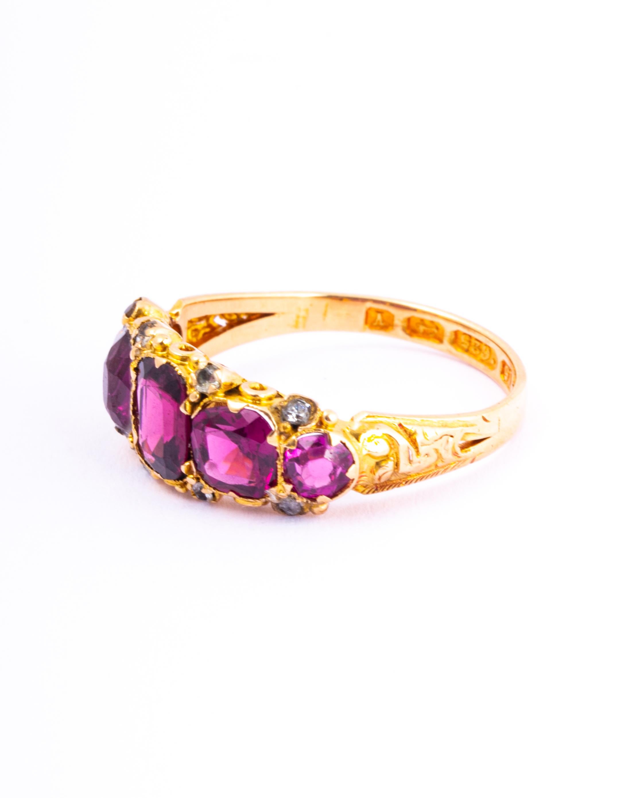 This stunner holds five deep pink tourmaline that are beautifully cut and catch the light just right to get that sparkle. They are set almost flush within the decorative 9ct gold band and also have pairs of rose cut diamonds set in between.  

Ring
