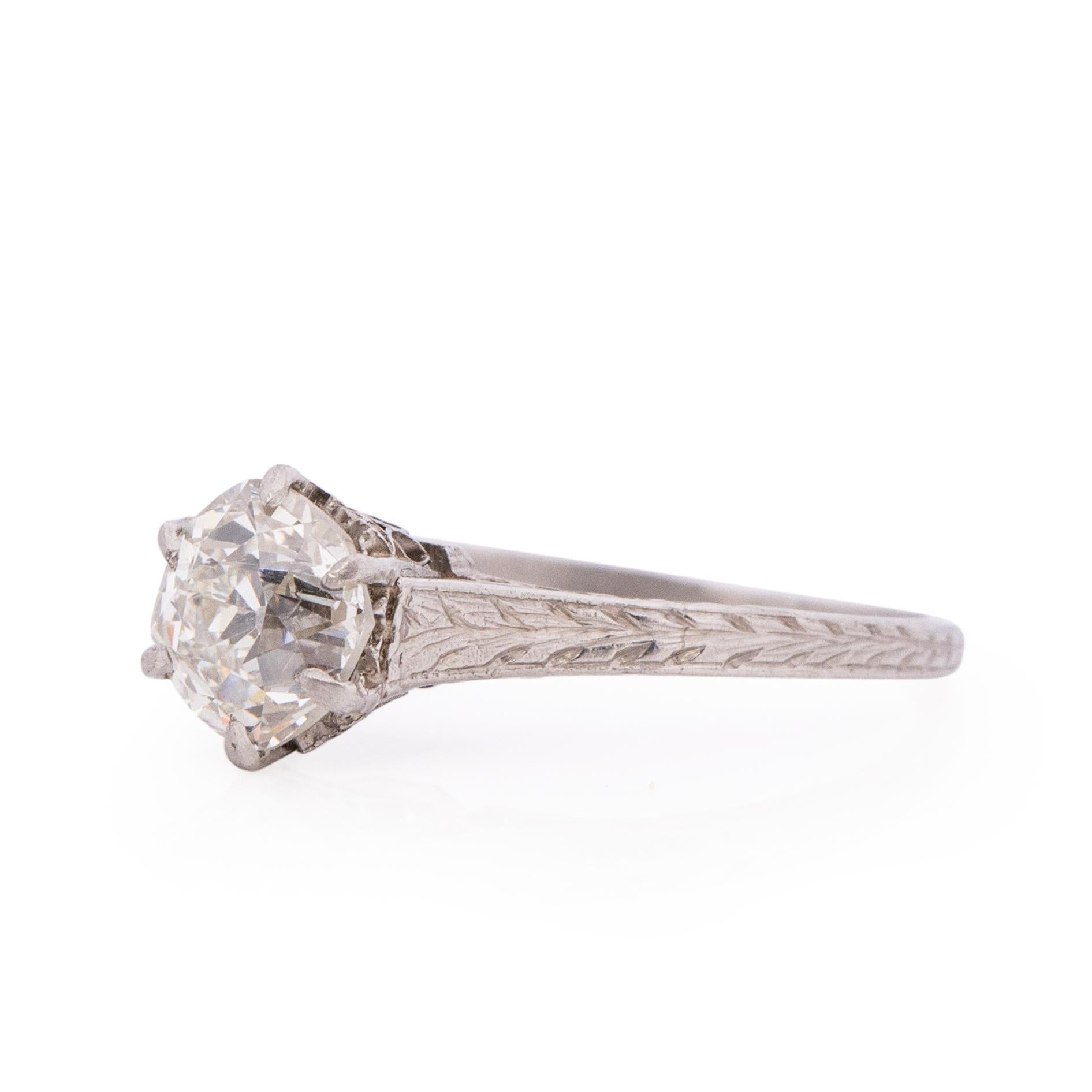 Here we have a simple elegant Edwardian solitaire engagement ring. The old European cut diamond sits in a cathedral setting. The gallery has gorgeous designed open work surrounded by cathedral shanks that have a clan chevron design nearly all the