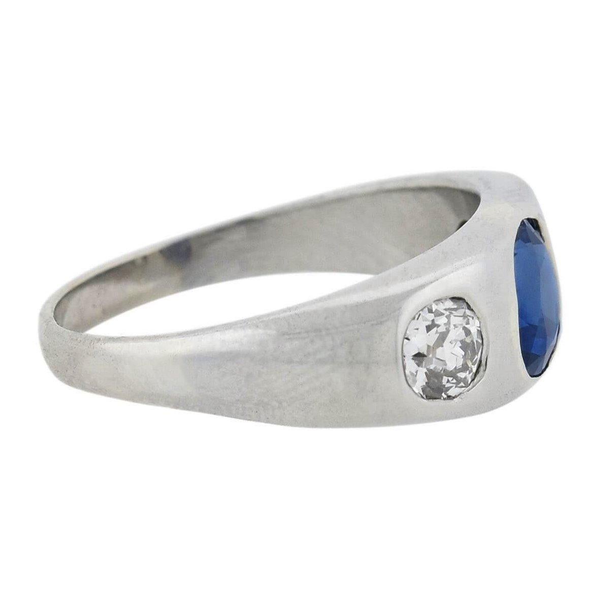 A beautiful diamond and sapphire three stone ring from the Edwardian (ca1910s) era! This stunning piece is crafted in solid platinum and features a sapphire center with two sparkling diamonds resting on either side. The vibrant sapphire is oval in