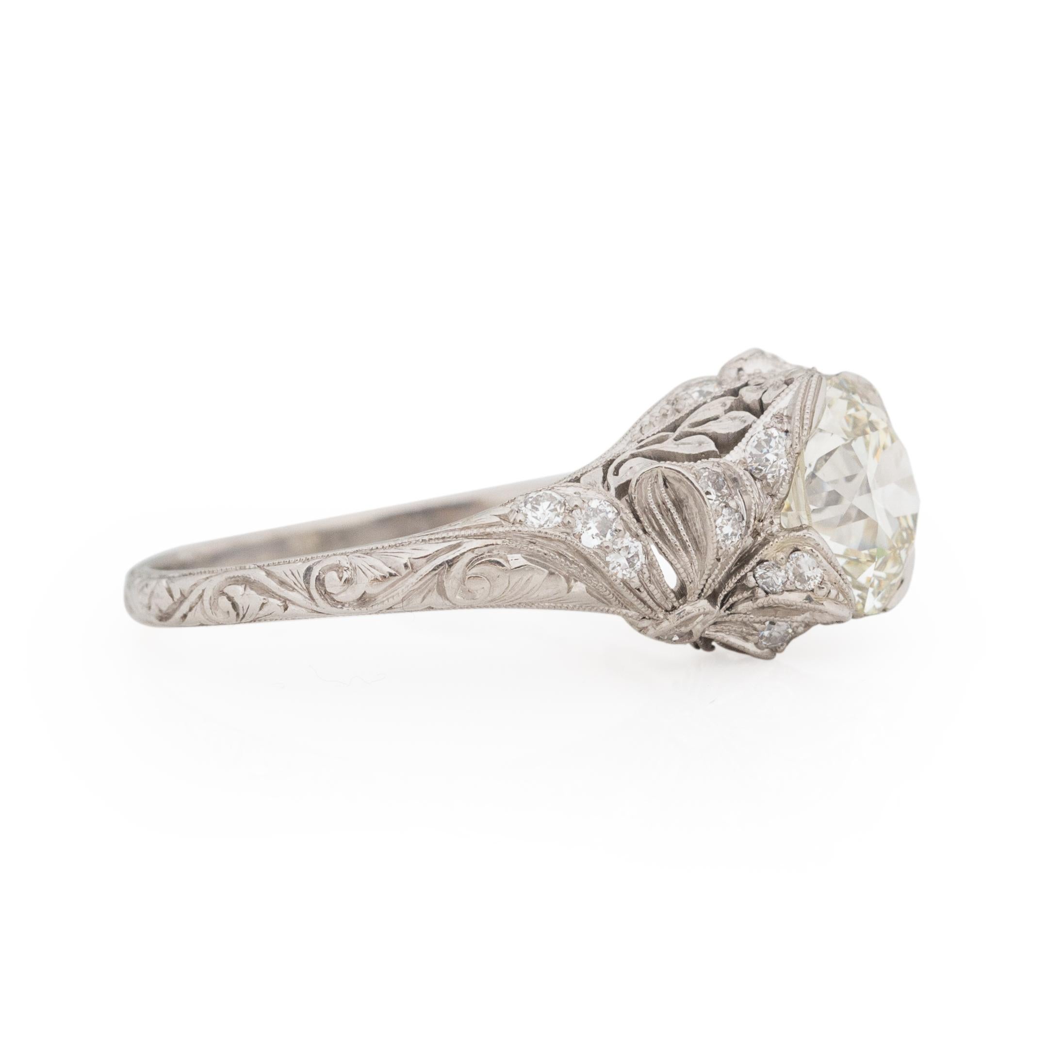 This Edwardian beauty has crazy intricate and impressive hand carved details, sure to take your breath away. Crafted in platinum this ring had survived the test of time. The flowing swirling design wraps all the way around the shanks, just as you