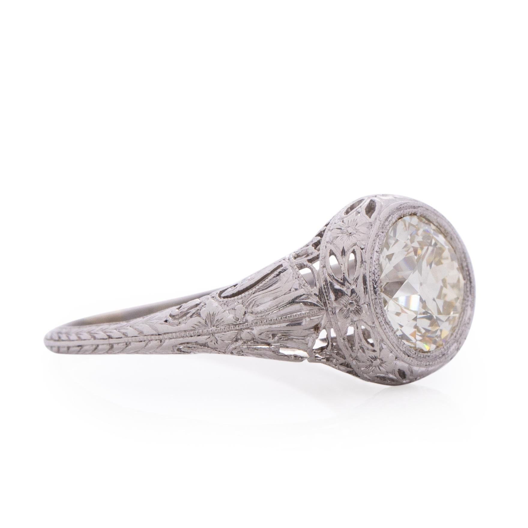 Here we have a spectacular 2.19Ct Brilliant cut Edwardian filigree ring. The details of this ring are unbelievably crisp and in pristine condition for its age. The floral filigree work wraps around the center diamond then wraps down the shank. A