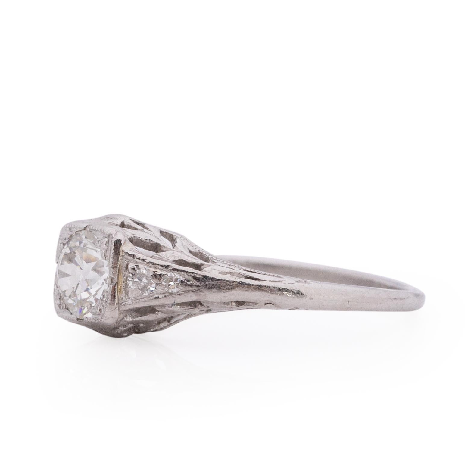 Here we have a beautiful solitaire engagement ring from the Edwardian era. Typical from this era the ring is crafted in platinum, with filigree details  giving off a floral femininity. In the center is a vibrant .50-.55Ct old European cut diamond