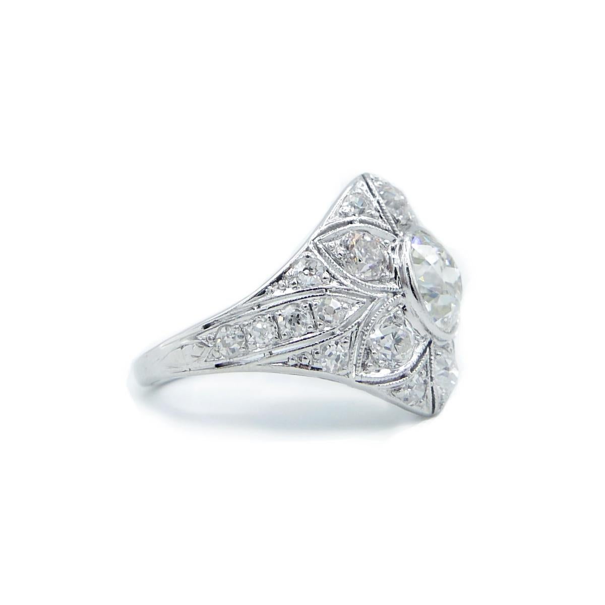 Edwardian Platinum and Old European Cut Diamond Flower Ring featuring Old European cut diamonds  Center stone is 1.50ct total diamonds are estimated at 2.8cts
F,G color, VS Clarity
Handmade in the early 20th Century by an extremely skilled