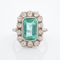 Edwardian Platinum and 4.5 Carat Colombian Emerald Ring and Diamond Ring