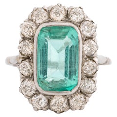 Edwardian Platinum and 4.5 Carat Colombian Emerald Ring and Diamond Ring
