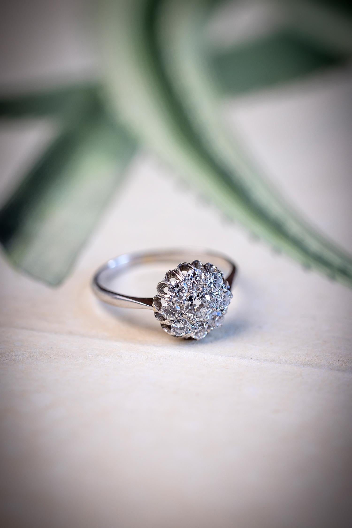 Dating from the early 20th century and so charming. Whether worn as a cocktail ring or engagement ring, the spread of this 0.75 carats crispy white old cut diamond cluster ring makes such an impressive statement on the hand. Viewed from the side,
