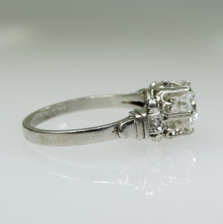 Period: Edwardian (1901-1920)
Composition: Platinum 
Stones:
•	1 Old mine cut diamond of I/J-SI1 quality that weighs 1.25ctw. 
•	4 single cut diamonds of H-SI2 quality that weigh 0.05ctw
Ring size: 7 ¼    
Ring face:  16mm by 8mm 
Rise above finger: