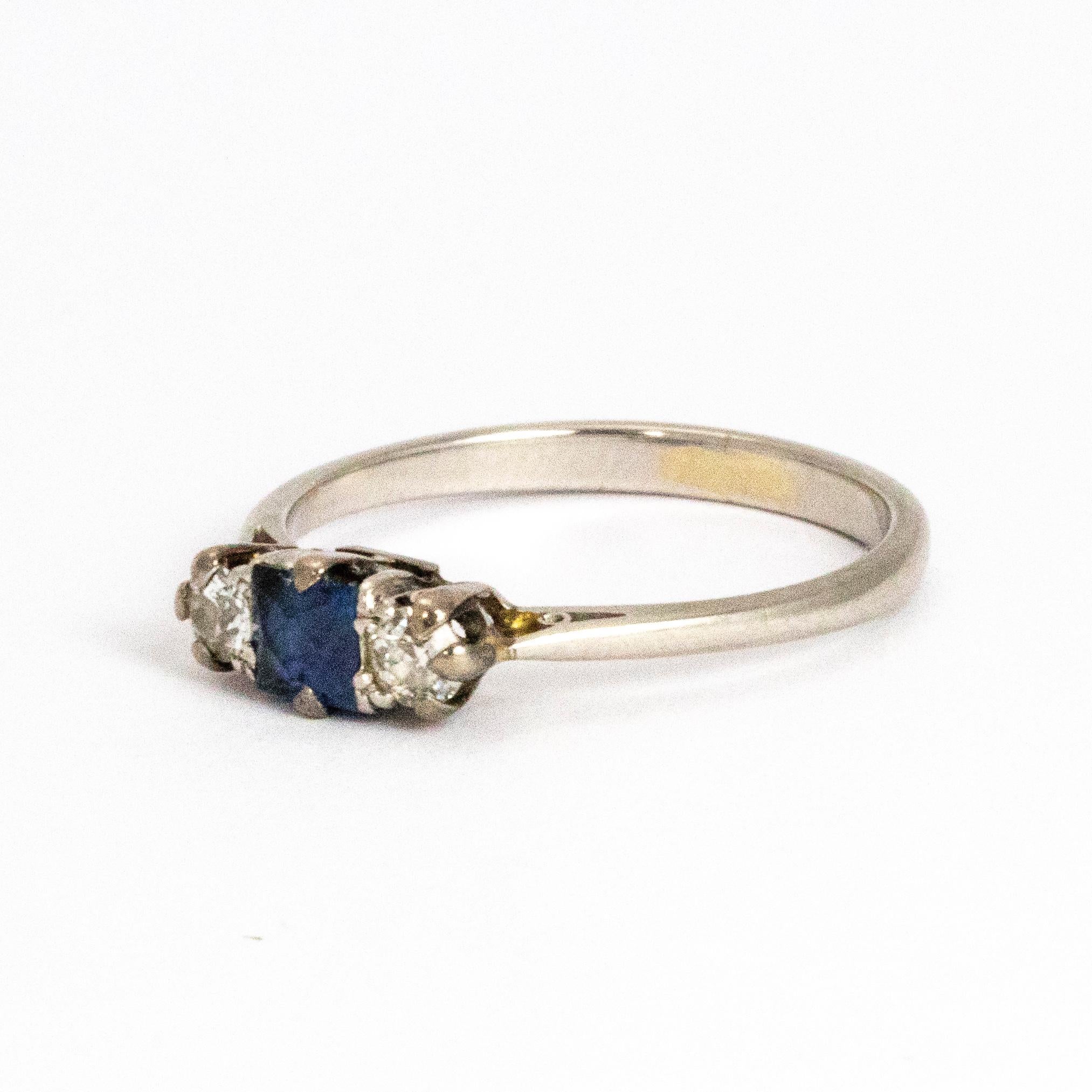 A precious antique Edwardian three-stone ring. Set with a stunning central square cut blue sapphire between two 10 point old European cut diamonds. Modelled in platinum.

Ring Size: N or 7