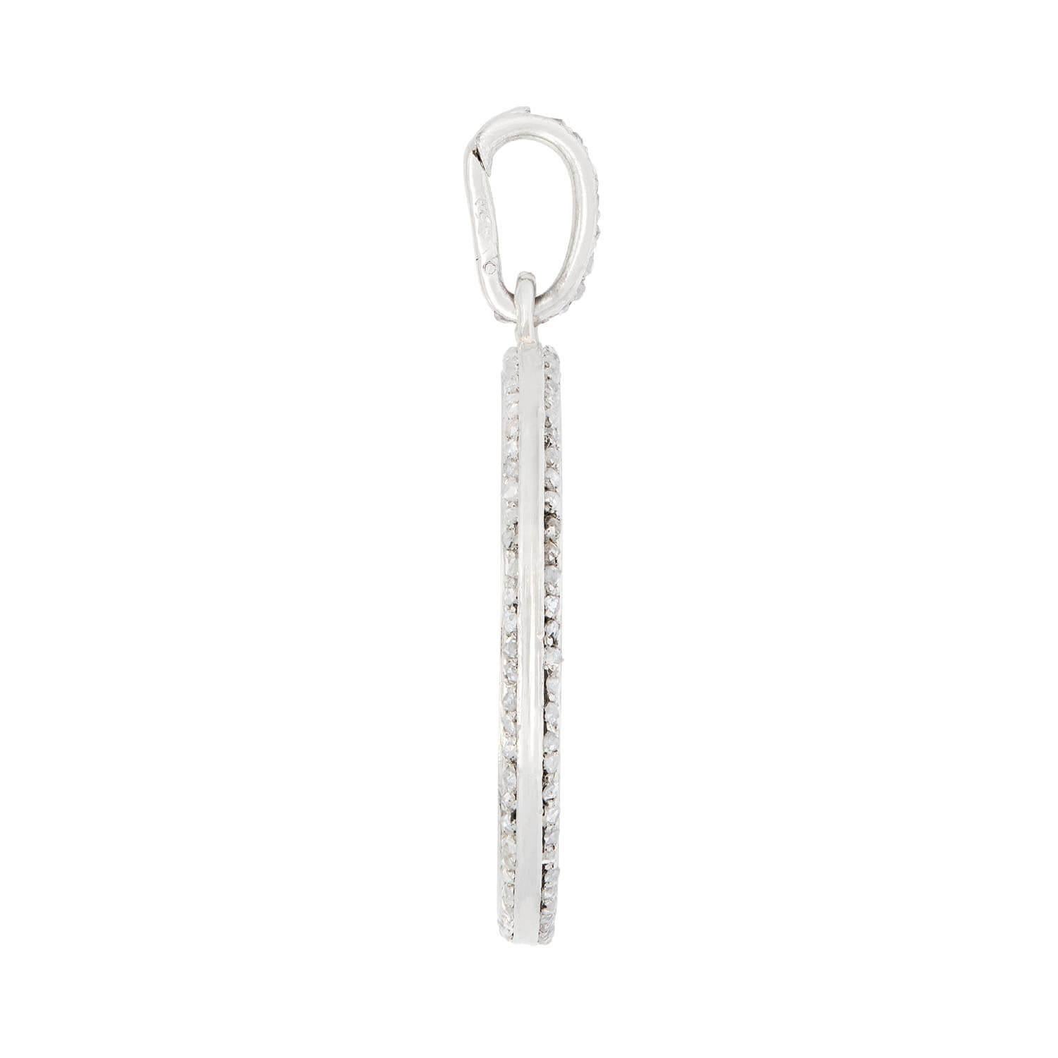 A lovely platinum and diamond disc pendant from the Edwardian (ca1910) era! Crafted in platinum, the disc shaped pendant is smooth and simple.Bordering the entire circumference of the disc are small, bead set rose cut diamonds. Completing the piece
