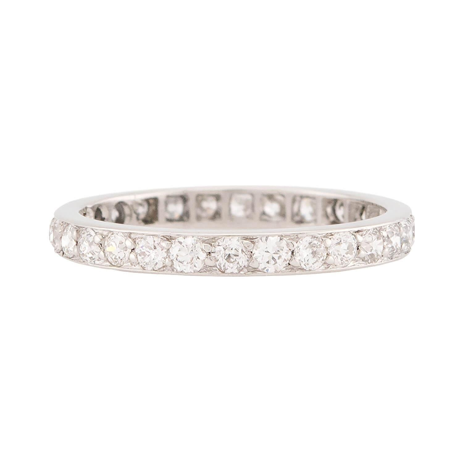 A stunning diamond eternity band from the Edwardian (ca1910s) era! This simple yet classic platinum ring displays a row of bead-set old European cut diamonds. The diamonds carry around the entirety of the band, and wonderfully complement the