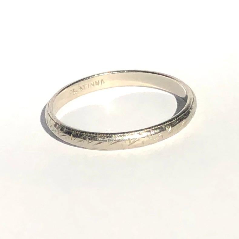 Simple platinum bands make the classic wedding band or can be worn as a stylish everyday wear ring to stack or wear alone. This particular band has sweet and delicate engraving all the way around it. Modelled in Platinum. 

Ring Size: M or 6
Band