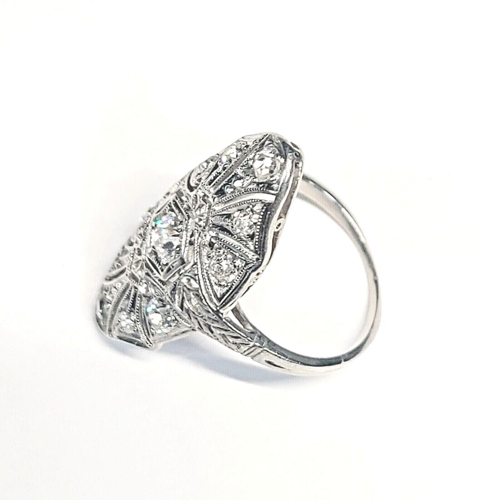 Presenting a:

Antique Platinum Navette 1ctw Diamond Ring Size 4.75.

The ring is made is solid platinum Navette style with filigree design.

Pave set with sparkling lustrous old mine cut natural diamonds.

The center diamond is approximately .25ct