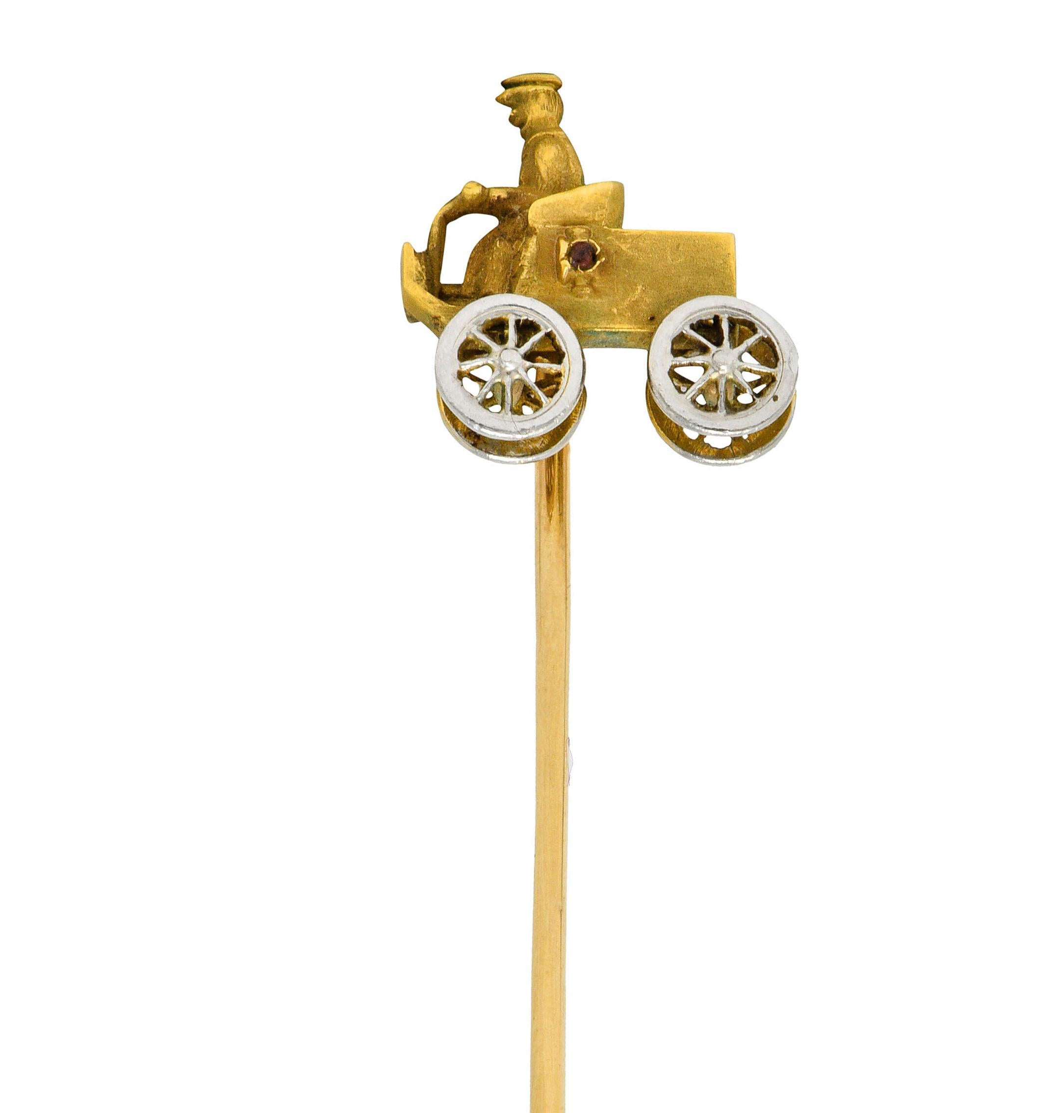Designed as an antique car with a highly rendered driver

With platinum-topped spoked wheels

And a red gemstone cabochon accent

Tested as platinum-topped 14 karat gold

Circa: 1900

Car measures: 1/2 x 9/16 inch

Total length: 3 1/16 inches

Total