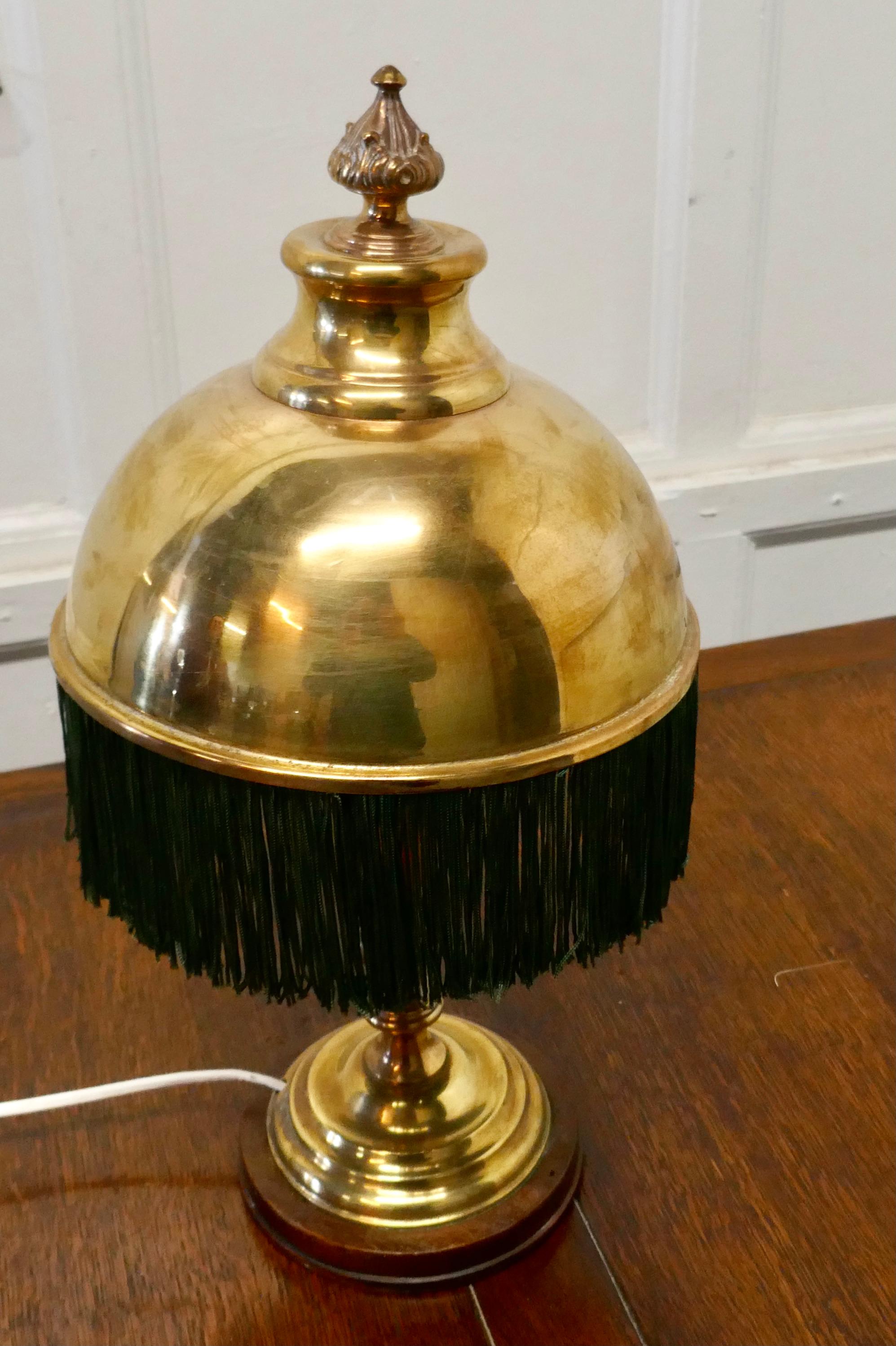 Edwardian reading lamp with fringed brass dome shade

A very unusual piece, the lamp is made in brass on a wooden base, it has a very unusual brass shade which throws the light downward for reading
The lamp is in good condition and working, it is