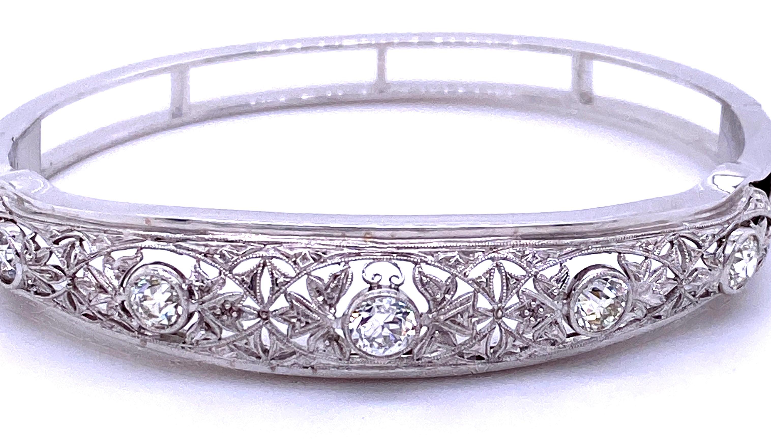 One platinum and 14 karat white gold hinged bangle bracelet featuring a platinum and diamond Edwardian brooch bezel set with five Old Mine cut diamonds, approximately 1.38 carats total weight with matching G/H/I color and VS1-SI2 clarity. The brooch