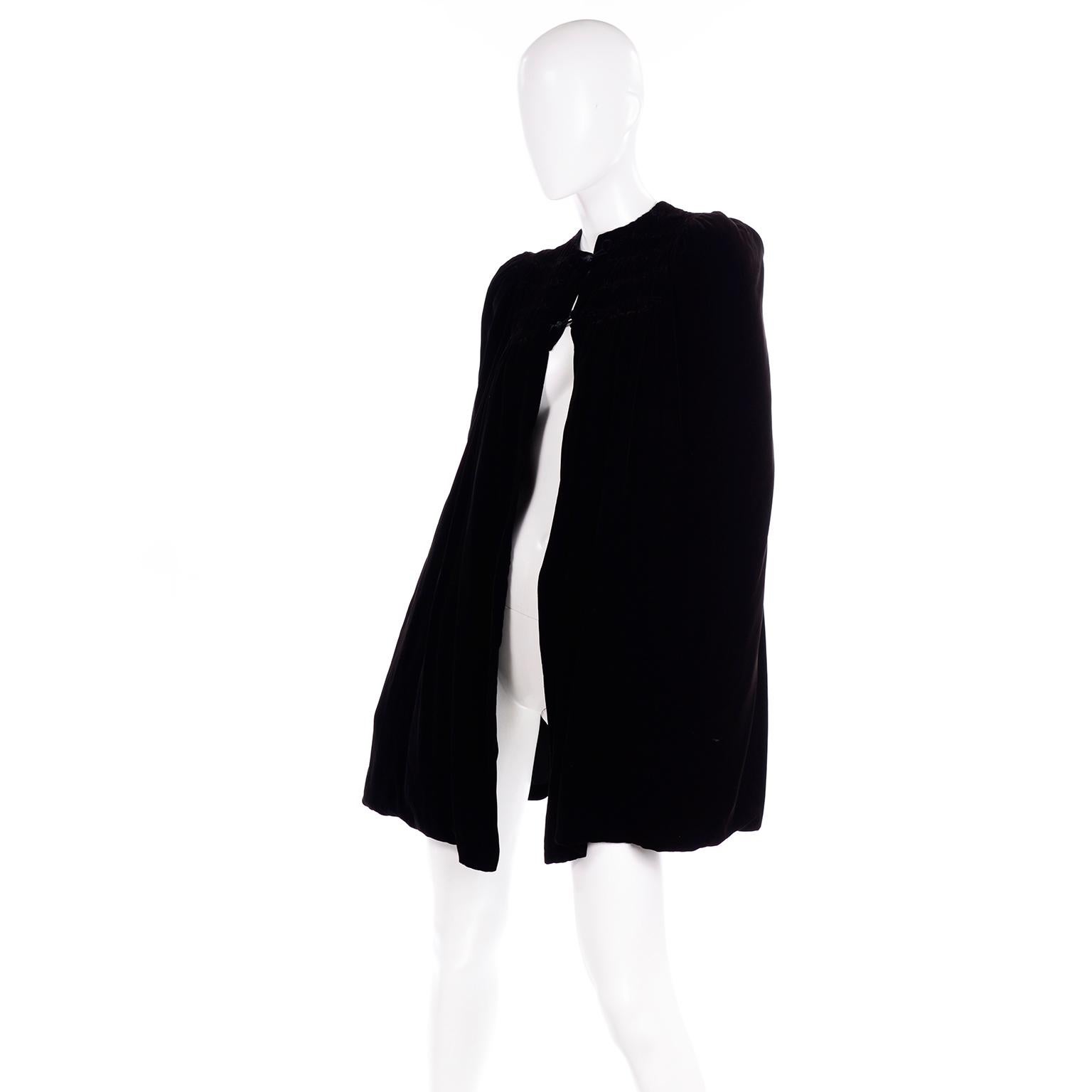 This exquisite vintage Edwardian black velvet cape is reversible, with lovely shirring along the bodice. The capet closes with a satin loop over velvet covered buttons. It has no arm holes and can be worn either with the black velvet out, or the