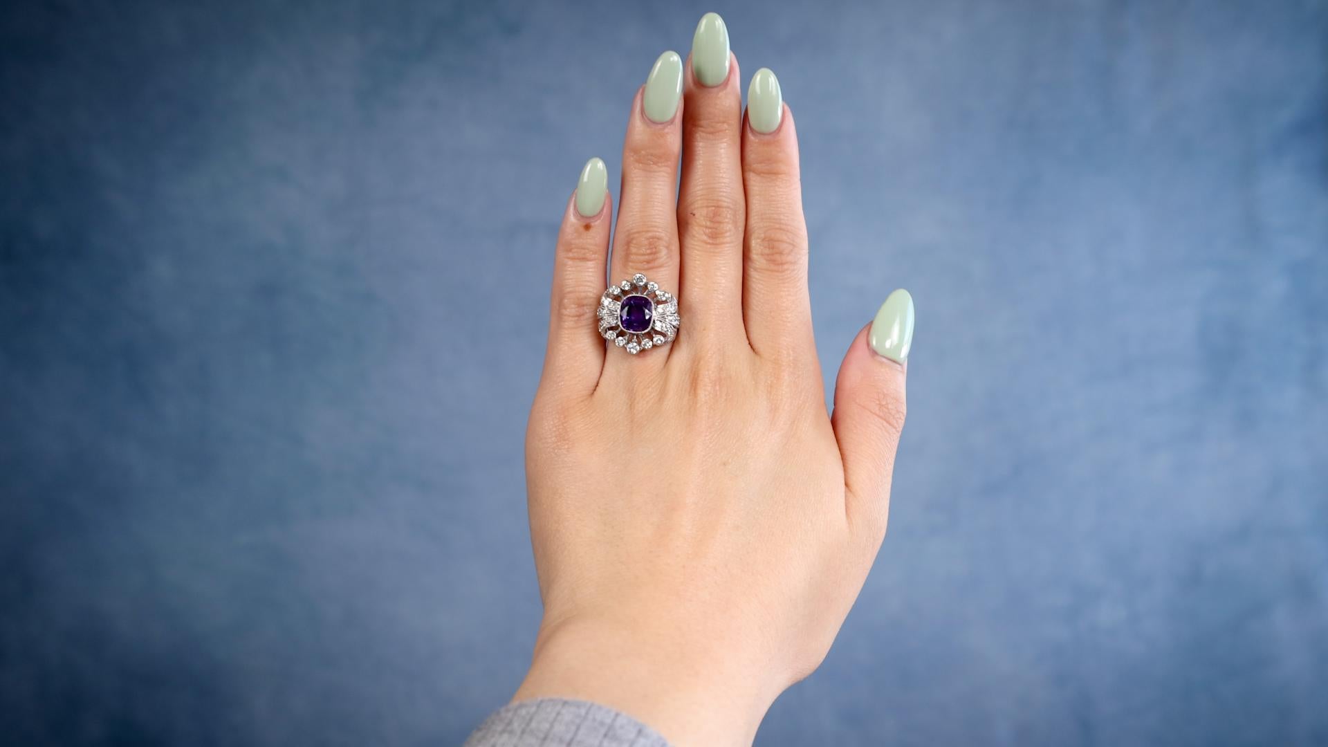 One Edwardian Revival Amethyst Diamond Platinum Ring. Featuring one cushion cut amethyst weighing approximately 2.20 carats. Accented by 32 round brilliant cut diamonds with a total weight of approximately 0.40 carat, graded near-colorless, SI