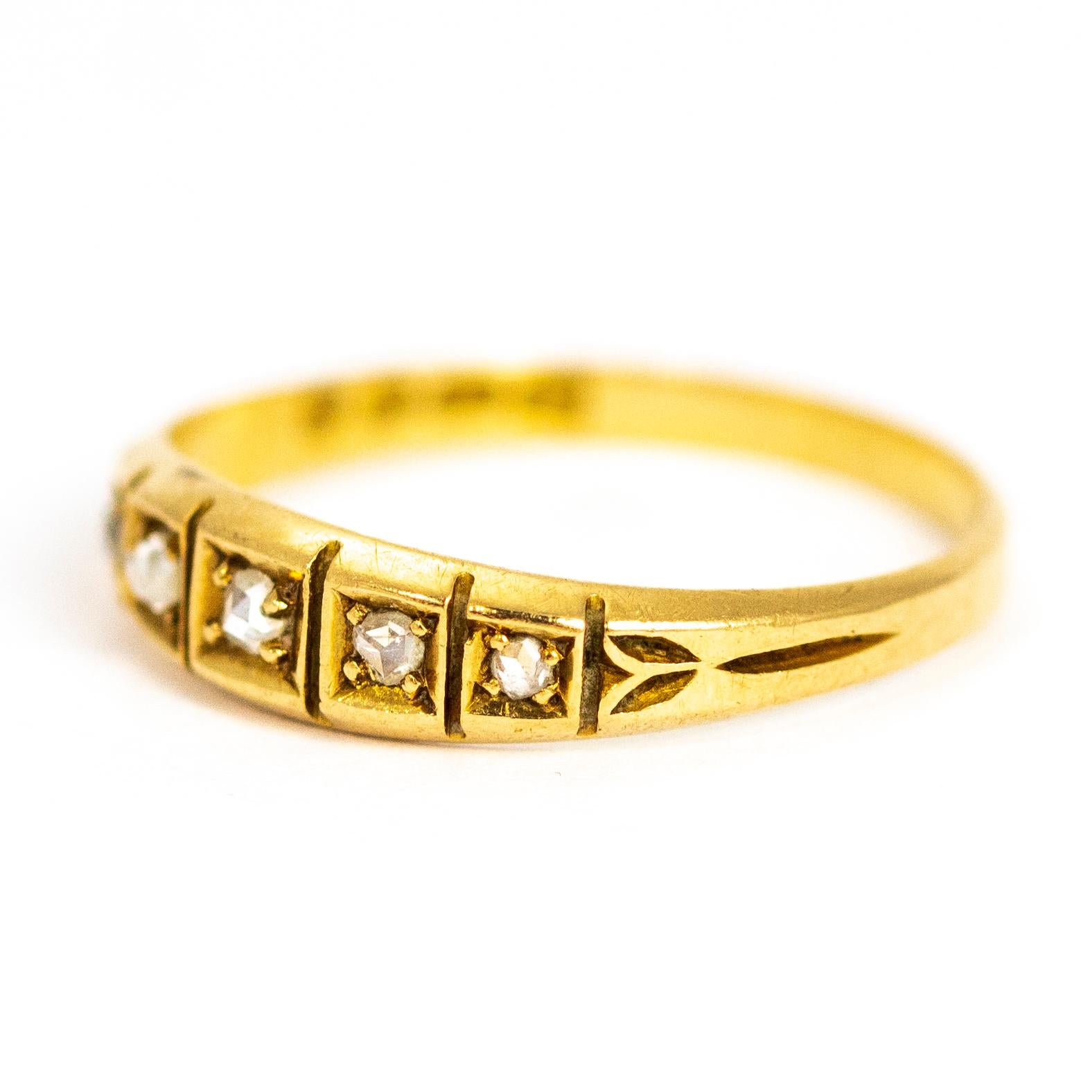 The five rose cut diamonds in this 18 carat gold band are set in graduated square settings. The shoulders of this band feature delicate leaf type detail. made in London, England.

Ring Size: M or 6 1/4
Band Width: 4mm
