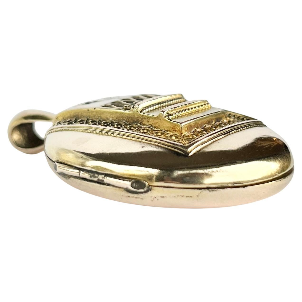 This gorgeous locket is modelled in glossy 9 carat yellow gold. The inside is left empty to fill with your memories!  On the front of the locket there is intricate moulded detail and three rose cut diamonds set within. The diamonds measure approx
