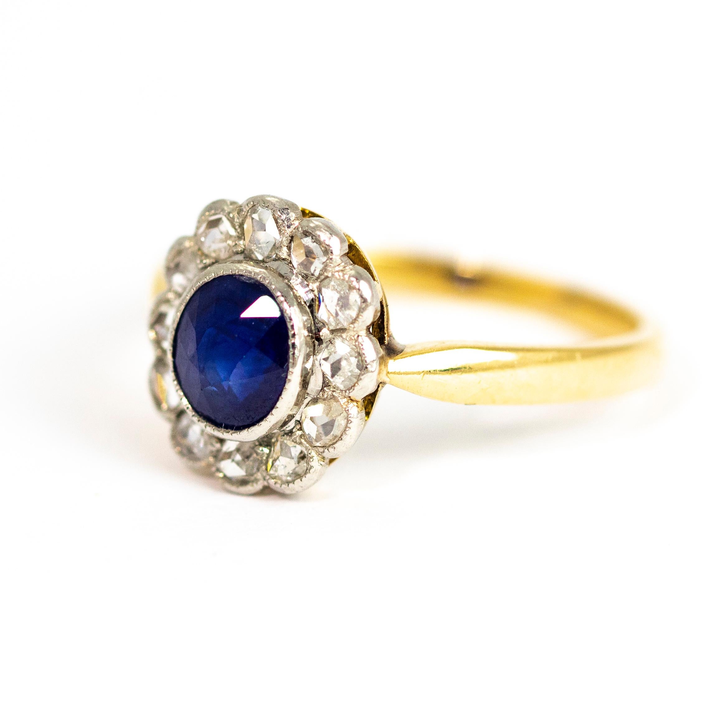 At the centre of this eye catching cluster ring is an oval blue sapphire and surrounding the stone is a shimmering halo of rose cut diamonds. The stones are set in platinum and the band is modelled in 18ct gold.

Ring Size: O 1/2 or 7 1/4