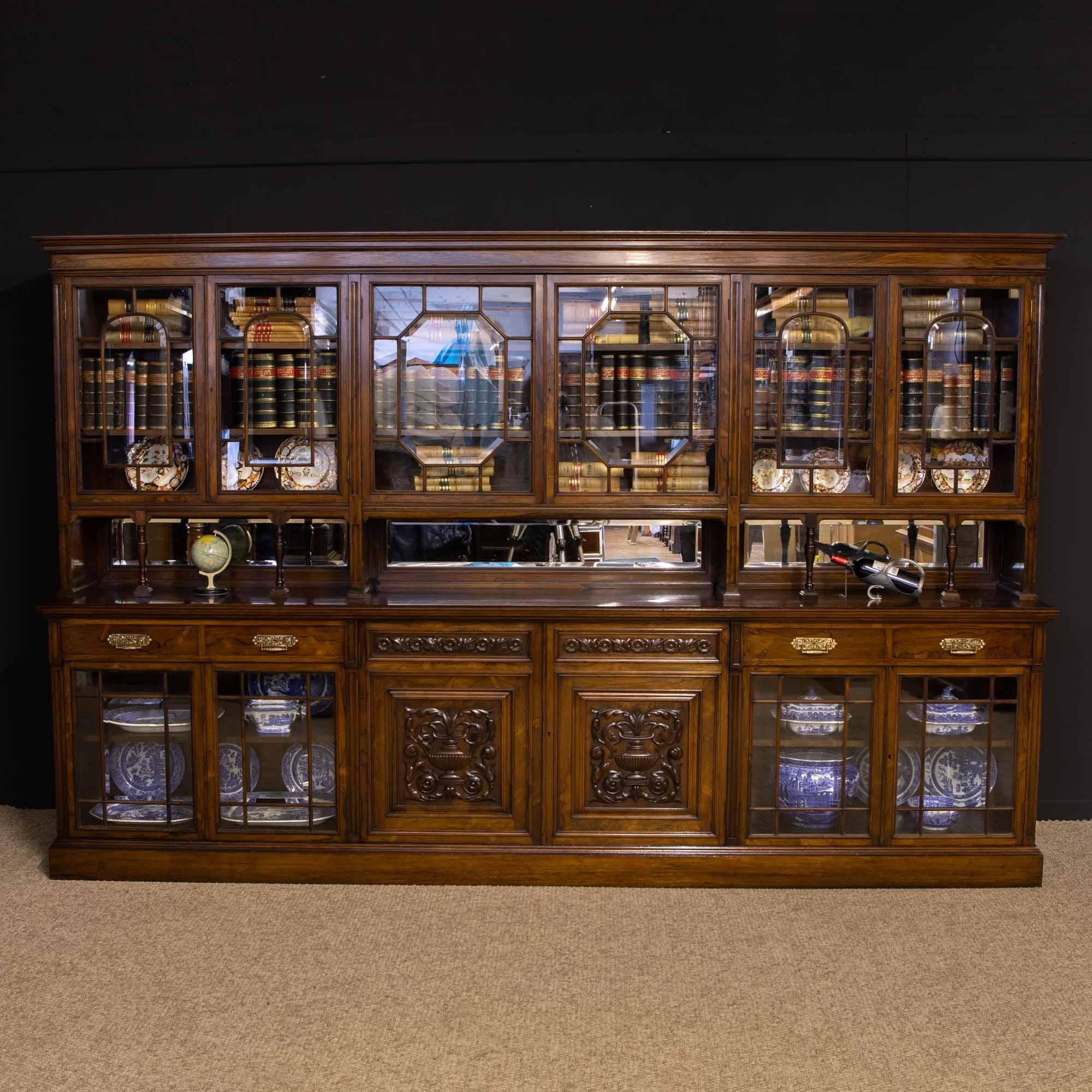 This is a magnificent Edwardian bookcase made from solid and veneered rosewood. Of large proportions at over 10 1/2 foot long but not particularly tall for it's length at 6'9 foot. The quality of the piece is outstanding with every effort gone into