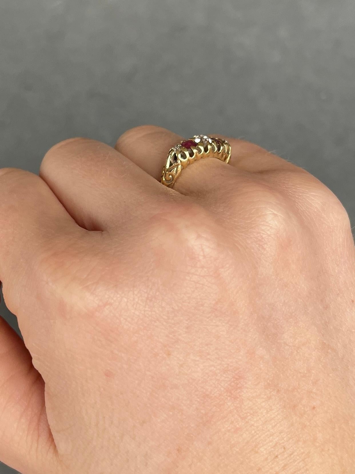 Set in this glossy 18ct gold ring are three Diamonds and two Rubies. The three diamonds total 30pts and the rubies total 30pts. The stones are set in simple claw settings and the shoulders have engraved detail. Hallmarked London 1903.

Ring Size: J